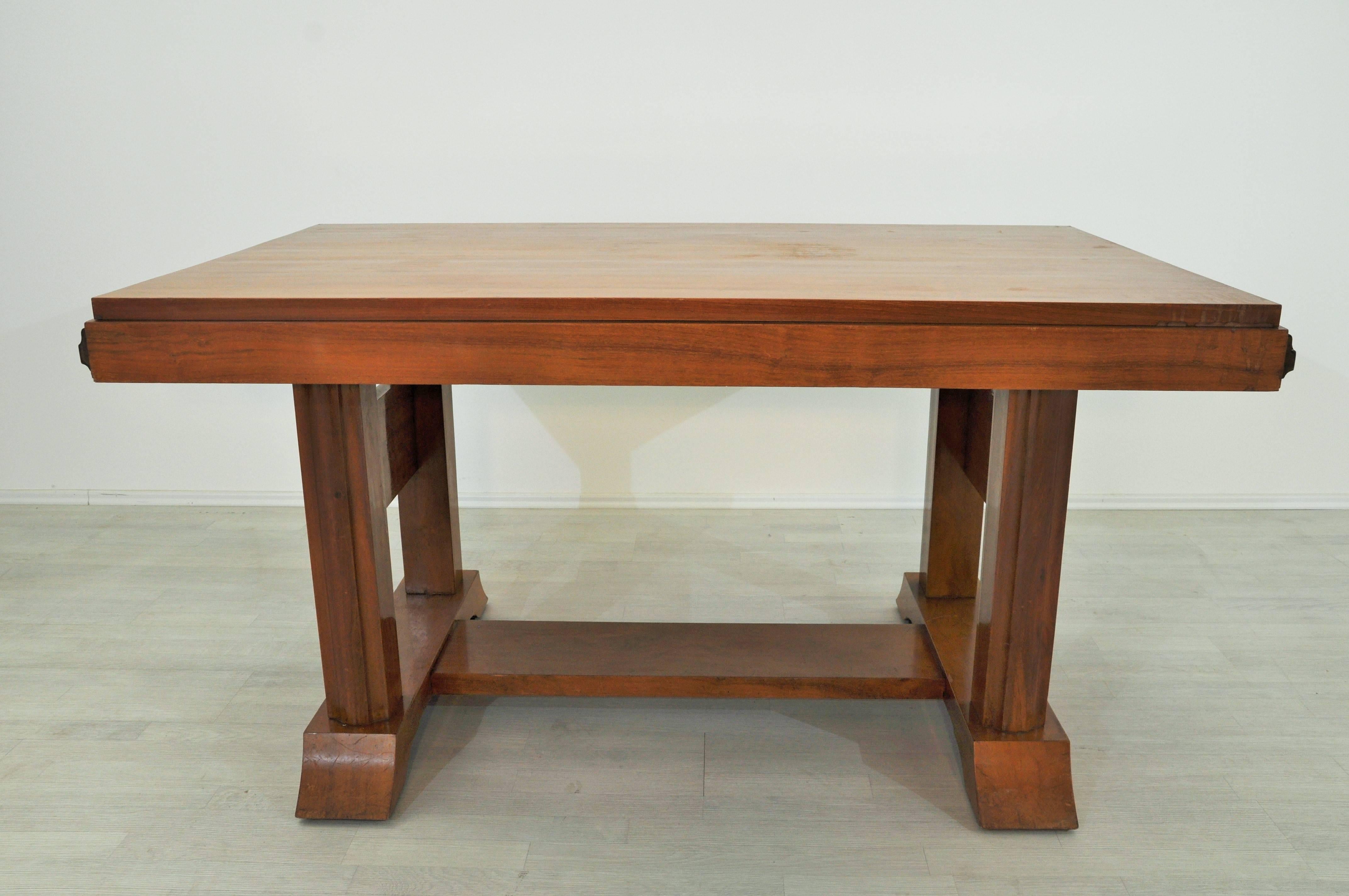 Beautiful wooden Art Deco dining table for your living room. Tabletop with walnut veneer and a rare check pattern on the legs. The wonderful character of the Art Deco design reassembles in this table.

 Original vintage walnut table.
 Beautiful