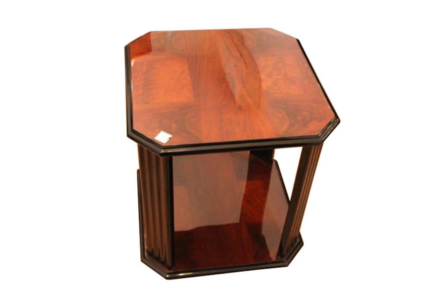 Beautiful side table from France of the 1930s. This piece of furniture convinces through its unique chess pattern veneer. The fluted legs are closing the elegant body language. Walnut wood on the top and bottom plate. Polished by hand after the