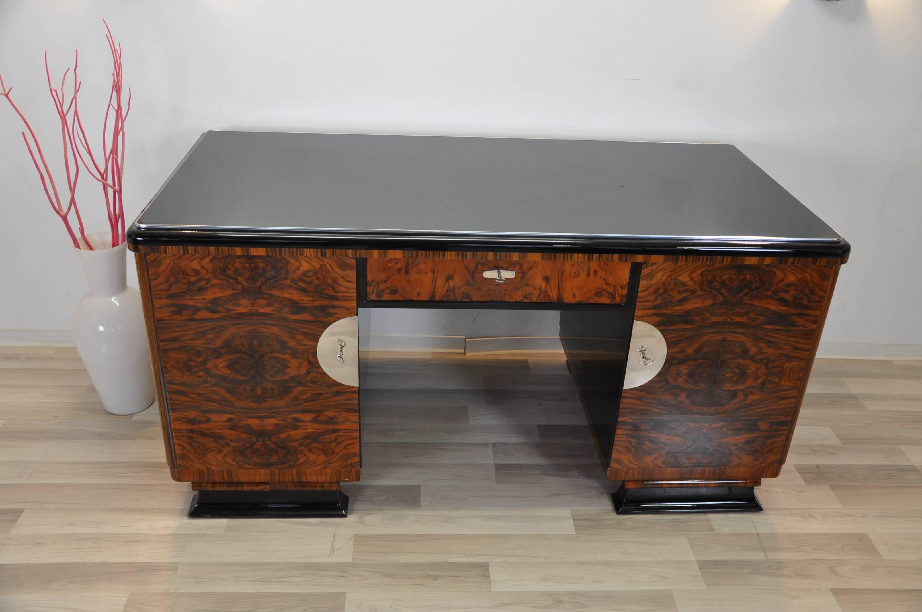 Unique Art Deco desk, according to the believes of the Art Deco the table is usable from both sides. Wonderful burl wood doors and drawer on the front, high gloss black shelves on the backside. Original French feet and Fine details on the tabletop