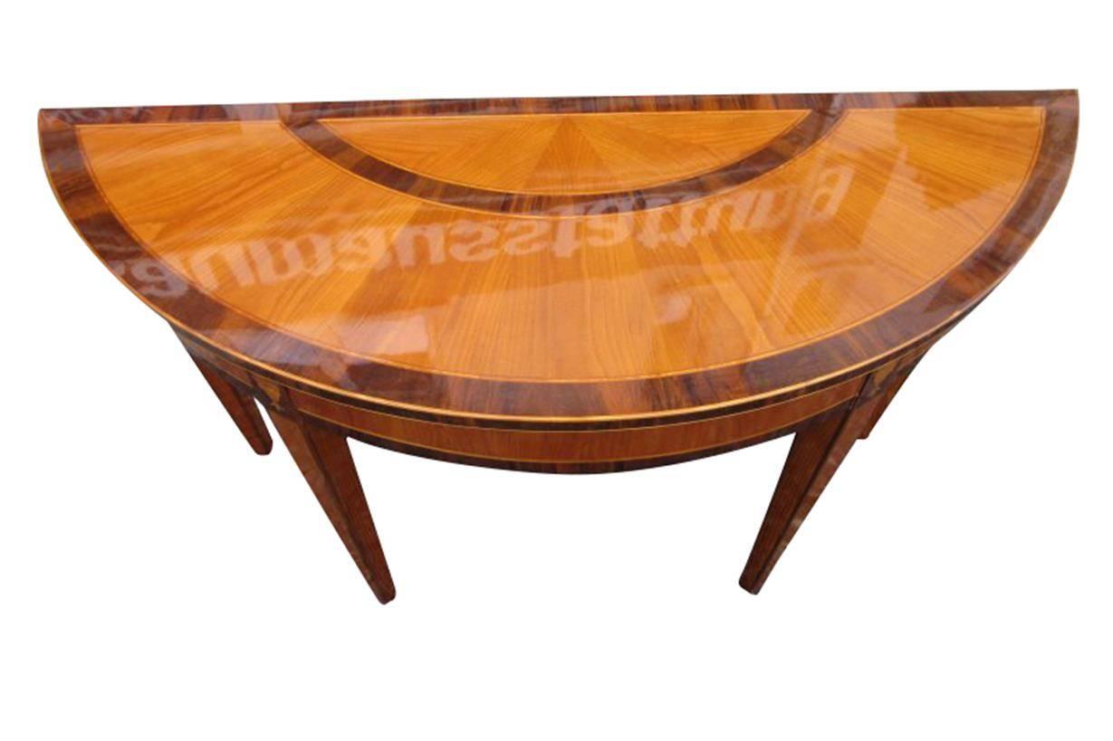 The beautiful console from the Biedermeier period is an artistic combination of cherry tree wood and walnut wood. The ornaments at the two front legs are a total eye-catcher.  Finished in high gloss and  polished by hand.
 