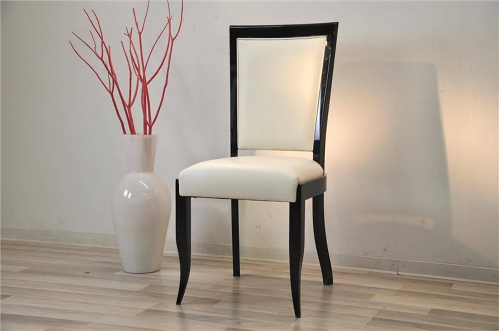 Comfortable Art Deco chairs with great seating comfort and elegant Design. High quality leather and wonderful piano lacquer on the curved feet and back panel. Different finishes like macassar veneer are also available, contact us for details.