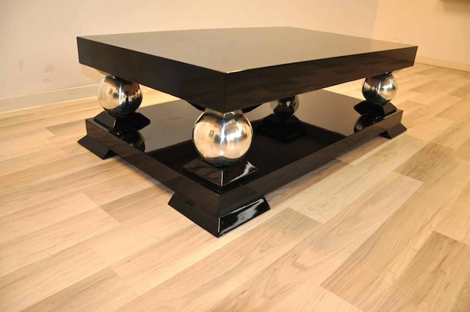 Coffee or sofa table with an Art Deco design. Rectangular body with elegant feet and big chrome balls. Finished with our signature black piano lacquer.
