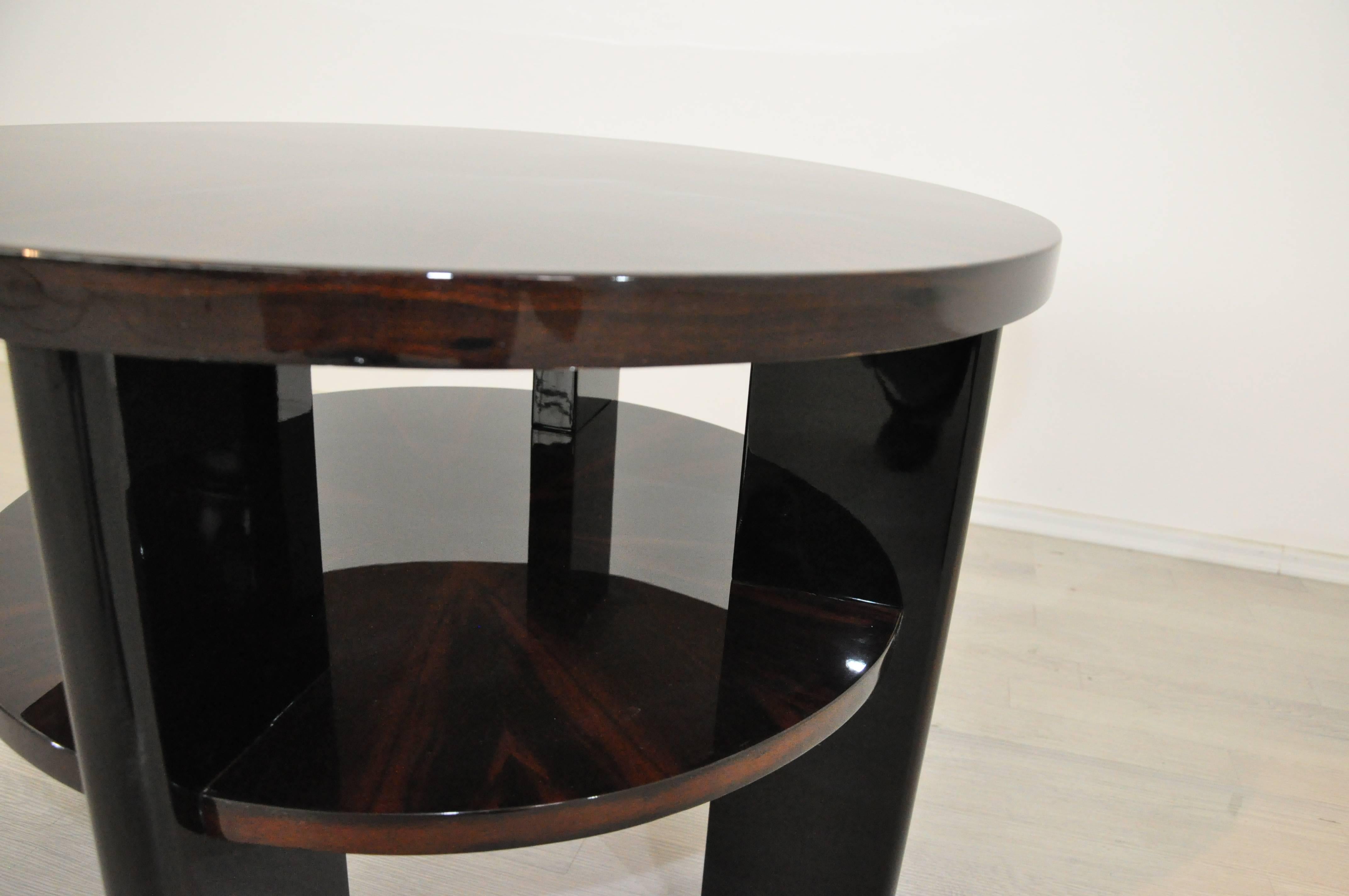 Classic Art Deco table with a simple but elegant design and four rounded legs. The wonderful Macassar veneer is restored with a costly highgloss polish. An eyecatcher for every living environment.

Original French piece from the 1930s
Classic and