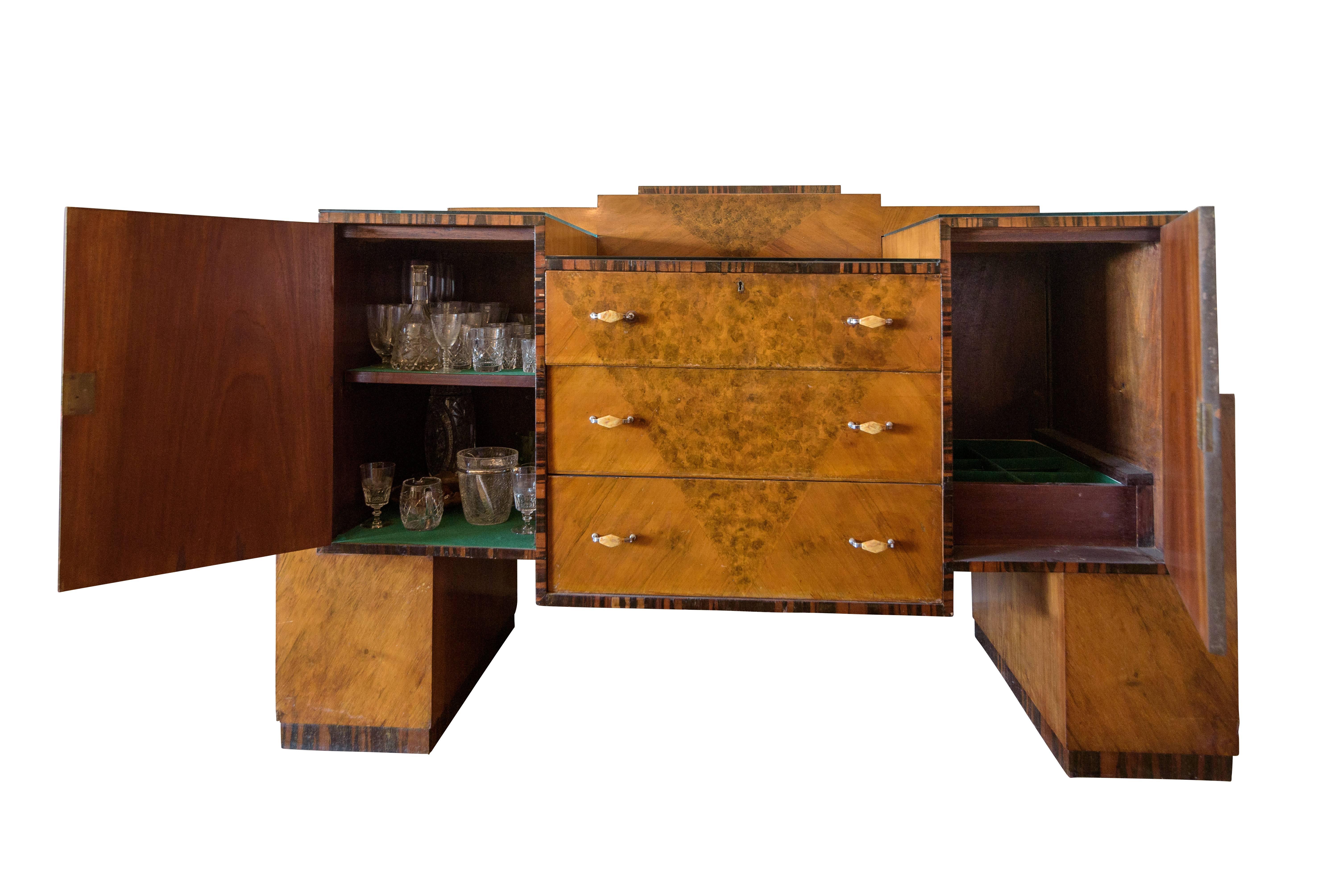 Wonderful Art Deco root wood drybar or buffet from the 1920s. Original piece with a straight forward design and great brass handles. Offers plenty of storage space for glasses, bottles and serving ware as well as a fabric covered drawer and