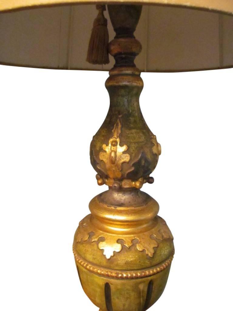 These charming table lamps are manufactured in Italy, circa 1970. They were made in the wonderful baroque style, therefore fit into every living room. The foot is made of wood in a greenish-golden tone and is detailed with gold-colored rosettes to