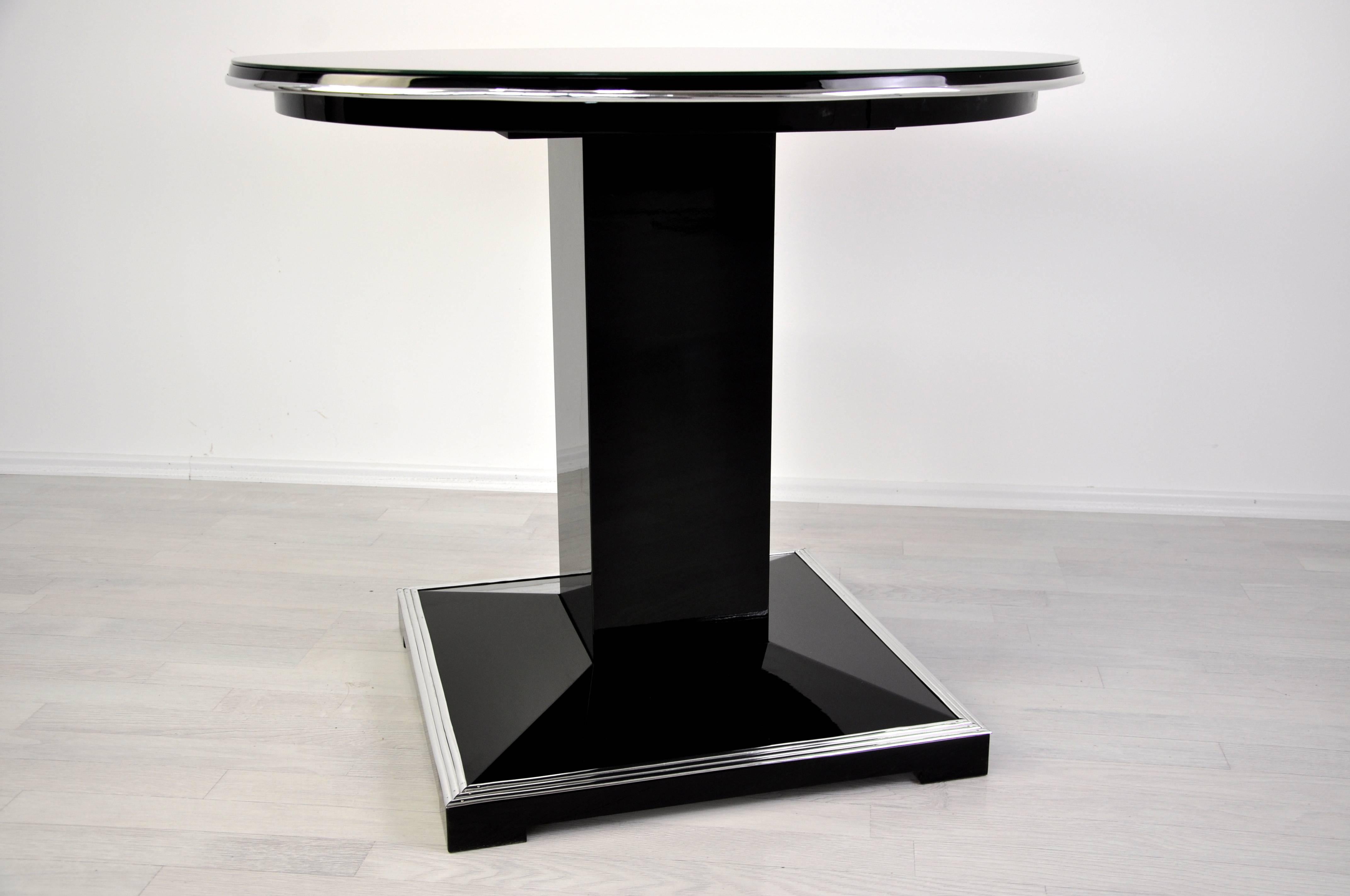 Wonderful lounge table from France. A real eyecatcher with a square foot and fine chrome applications. The circular tabletop is available with a lacobel glass plate for everyday use or with our signature hand polished piano lacquer. Unique design