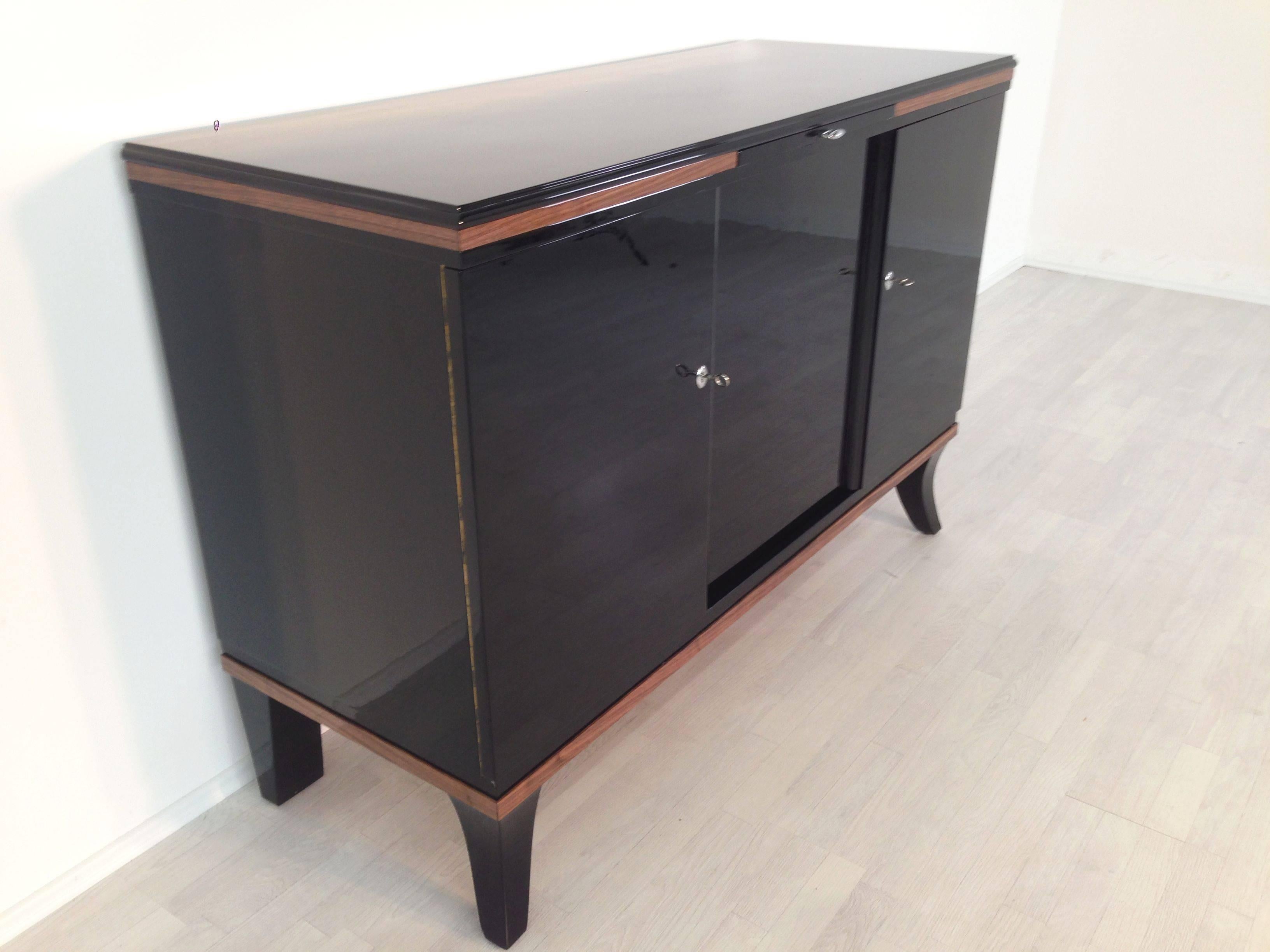 Simple Art Deco style sideboard with great walnut details and curved feet. A straight forward but very elegant design with unique details.

    - high quality piano lacquer
    - extension with marble plate
    - clean interior
    - mahogany