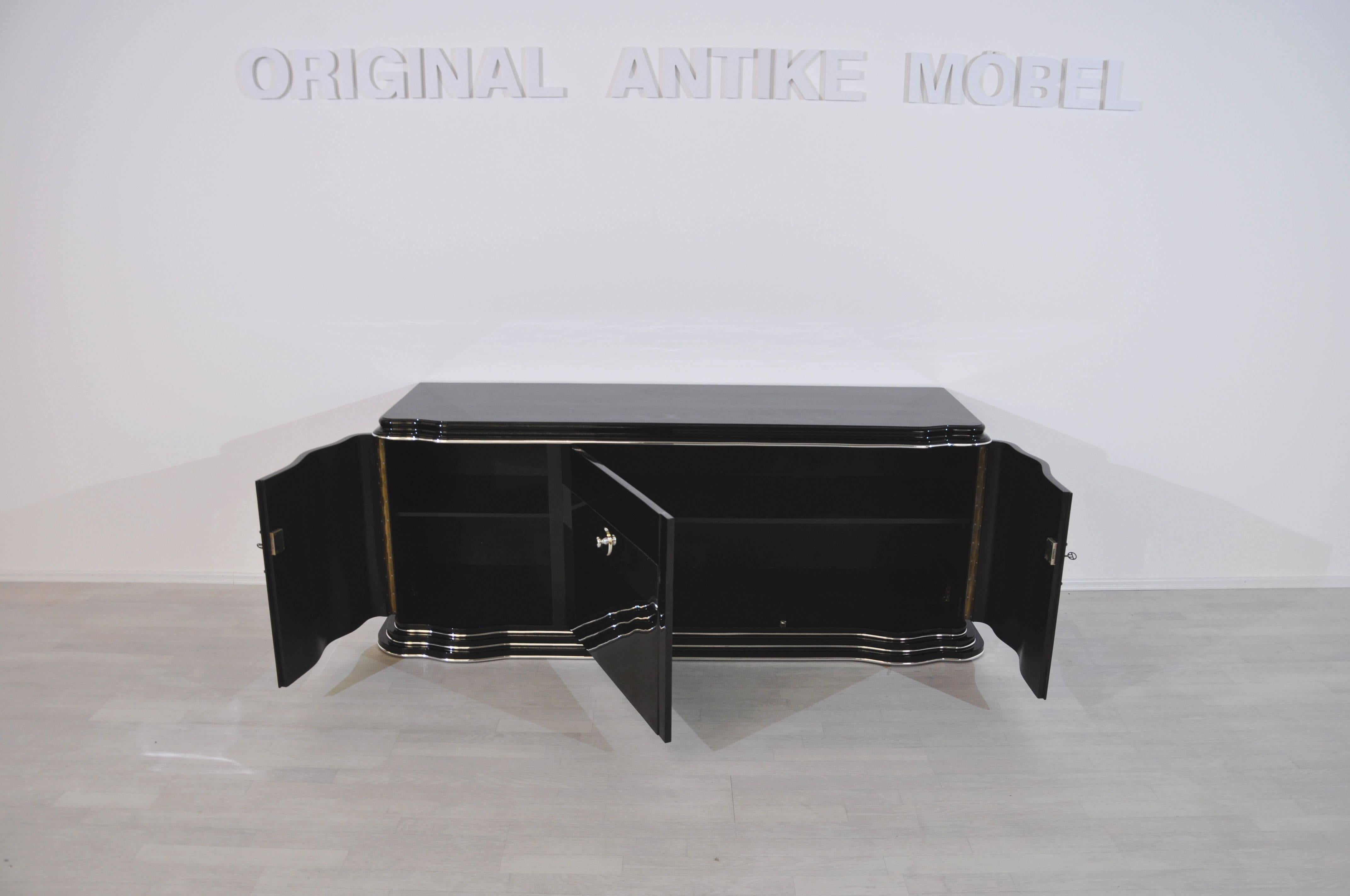Wonderful Art Deco style lowboard or sideboard finished in high gloss black. With a unique mirror stripe and fine chrome details. The original was sold to Sweden, while this perfect rebuild is now for sale. Unmatched quality without any flaws.