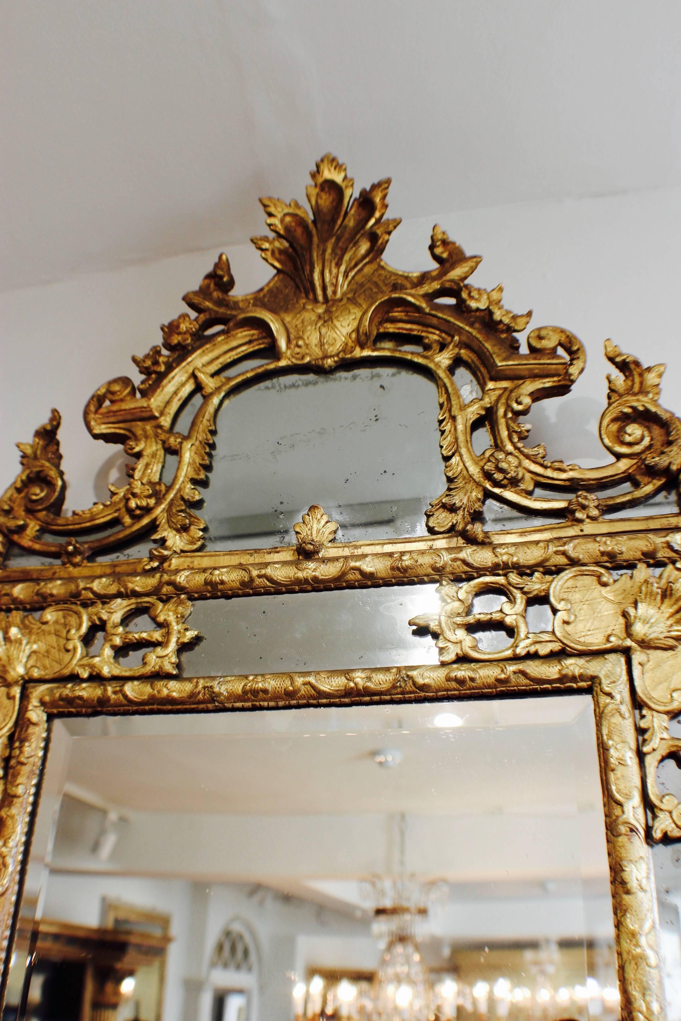 French An unusual size Regence gilt-wood mirror, circa 1720-30