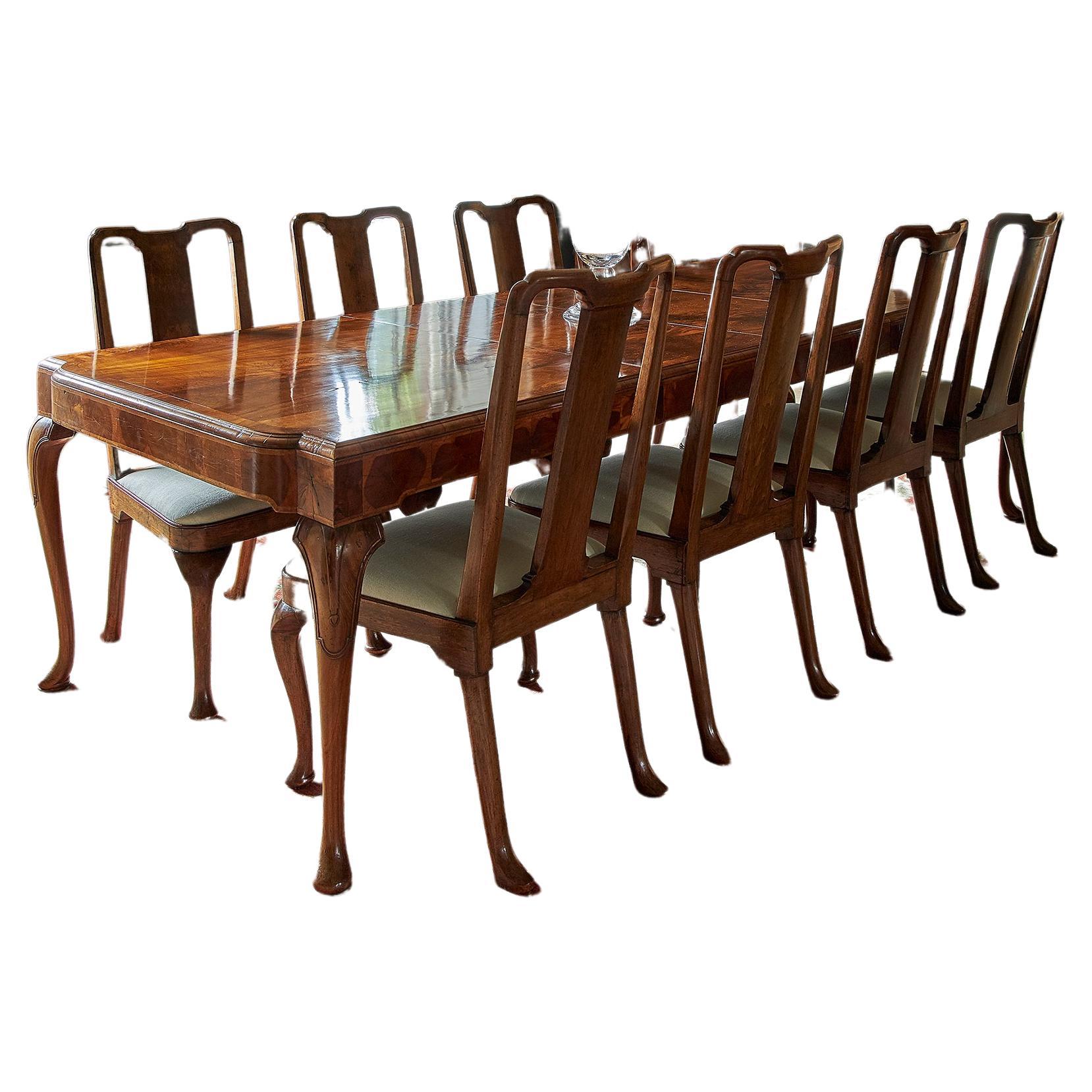 A George I style walnut veneer extending dining table and twelve dining chairs For Sale