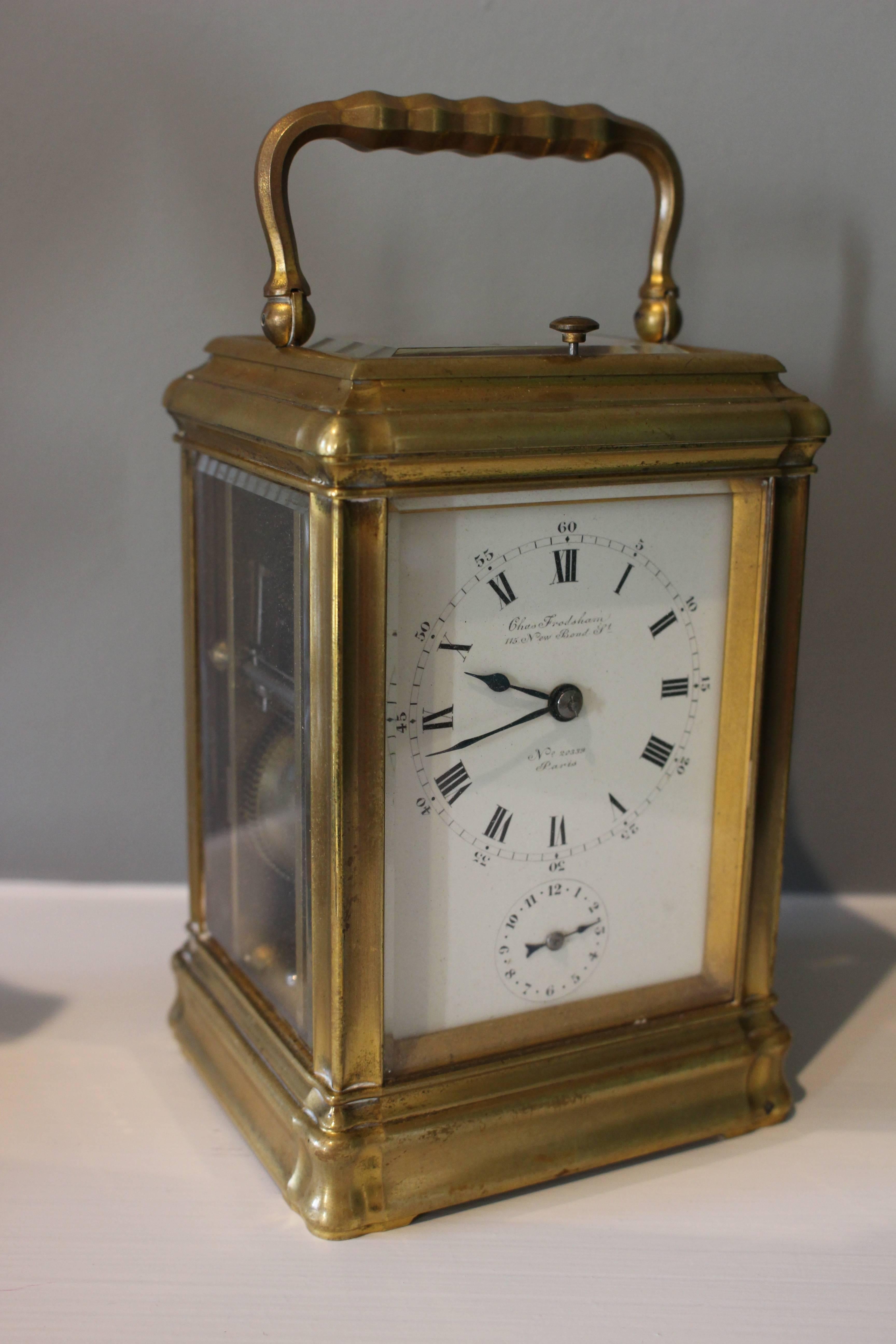 A fine brass-cased carriage clock by Charles Frodsham & Co Ltd, late 19th-early 20th century. With eight day repeat movement and alarm, striking on a gong, with lever excapement, the back plate and dial signed.