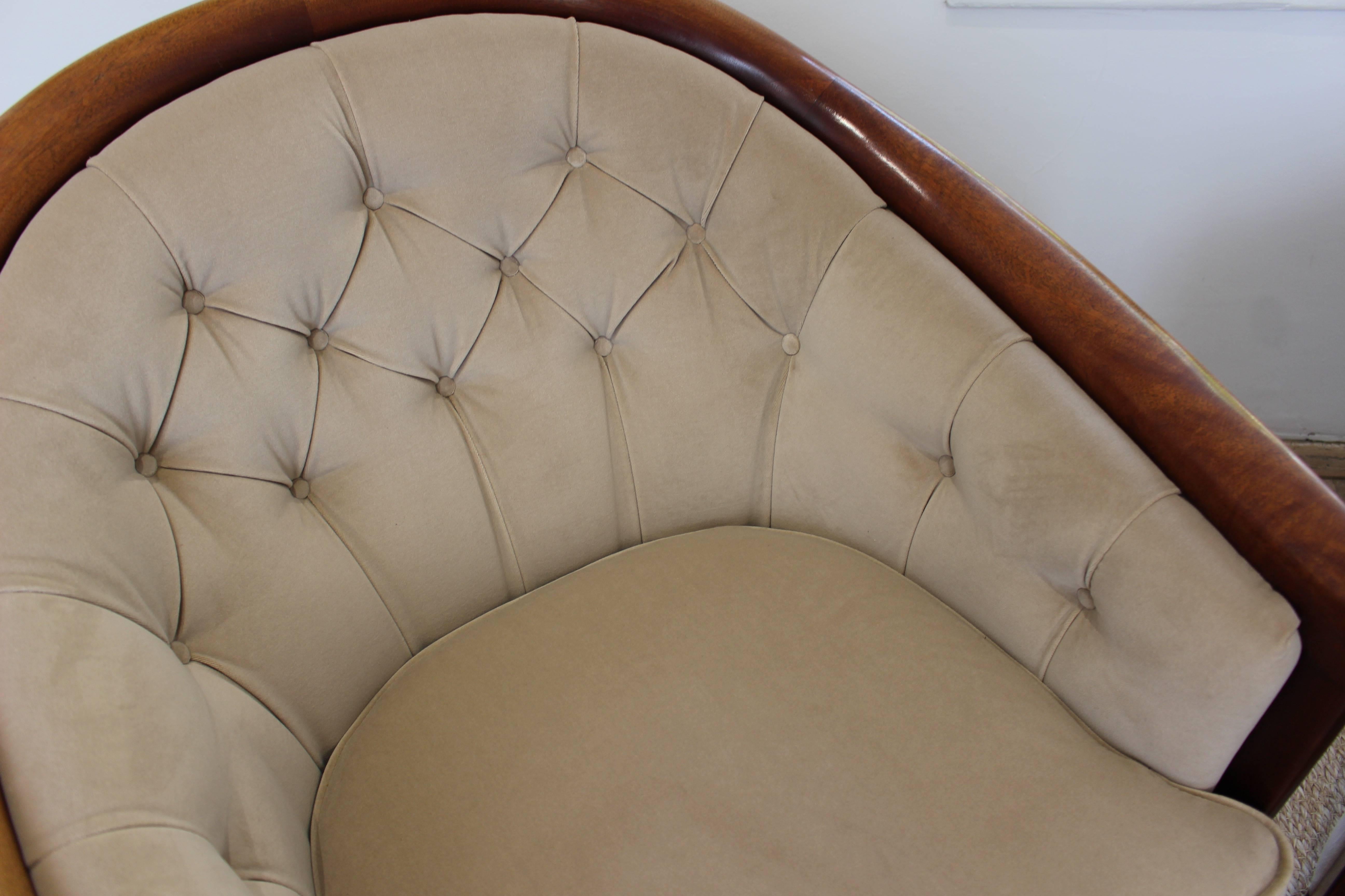 Elegant pair of Swedish wood tub chairs by Bertil Fridhagen, circa 1960. The chairs of generous proportions, in a rounded form with a polished dark wood frame, and light Pierre Frey cream velvet upholstery, with button detailing on the back. 

  