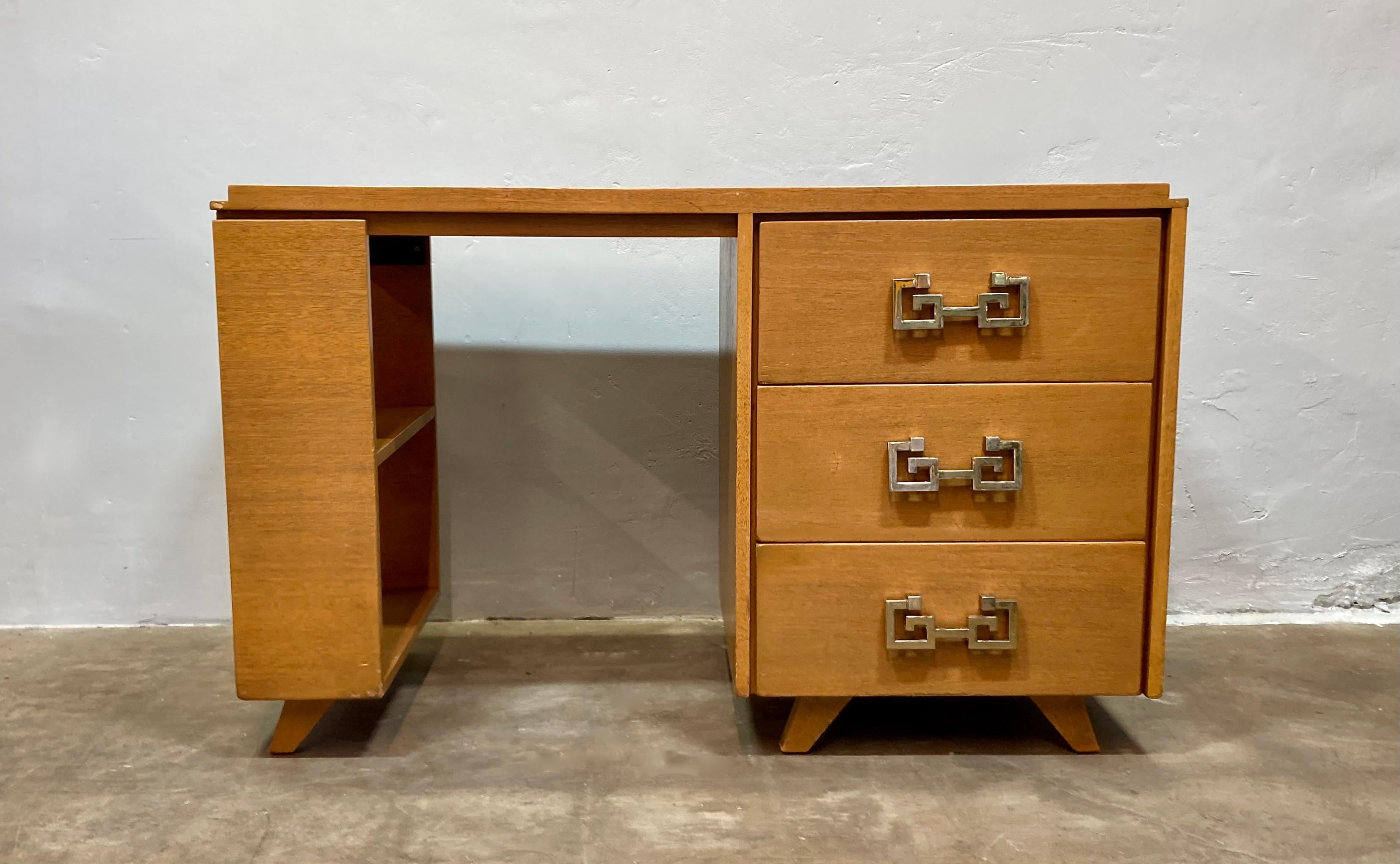 Mid-century modern desk with three storage drawers and built in shelving. Made of a lovely pale wood, and features fantastic vintage 