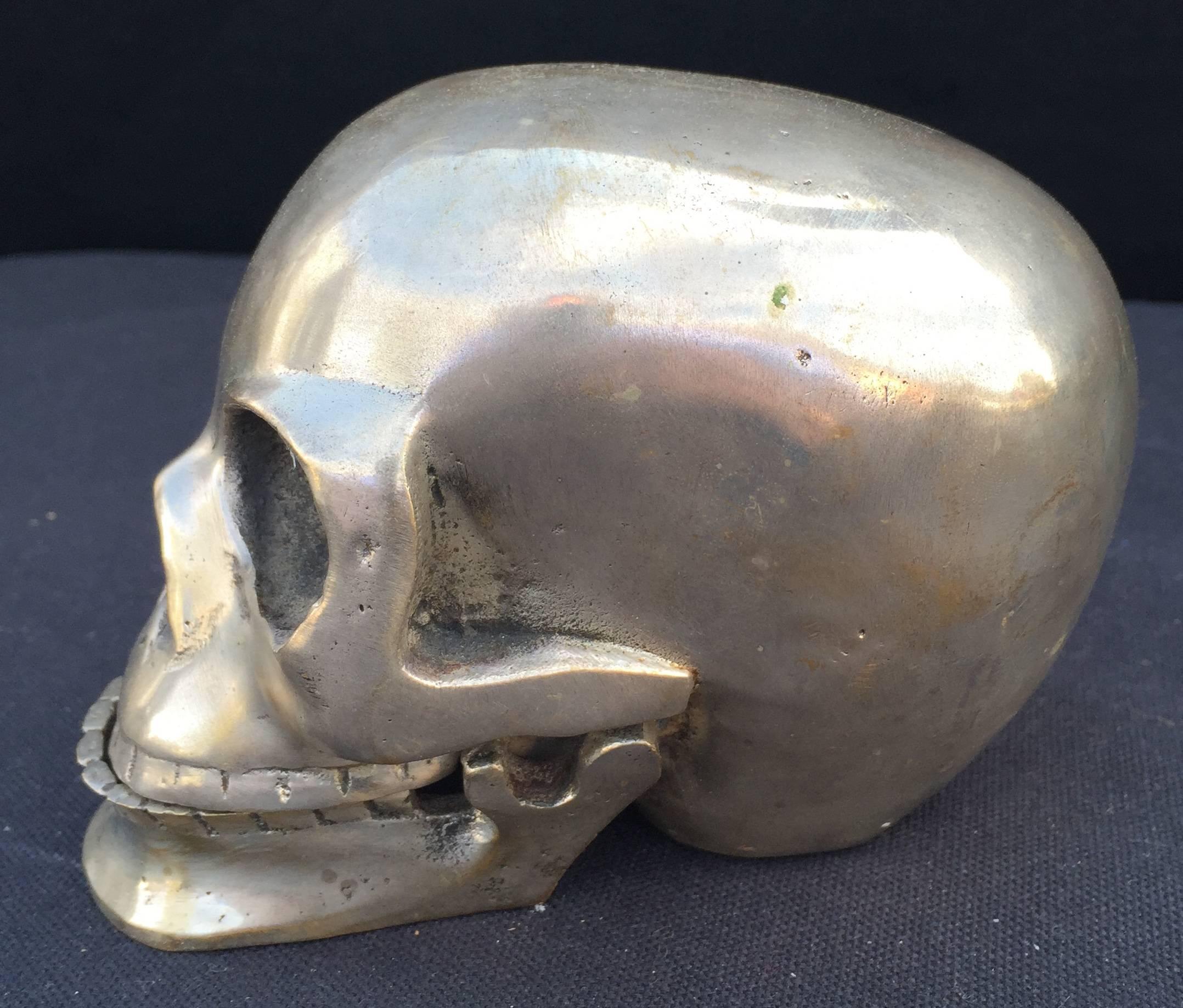 Nickel over brass skull sculpture with hinged mandible. Good weight.