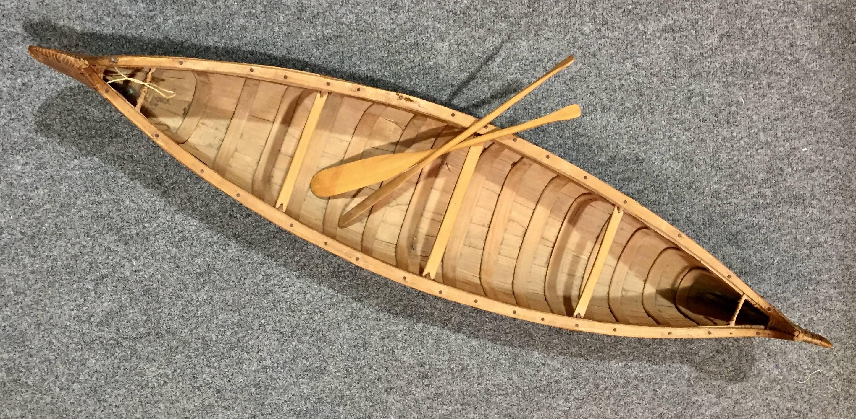Good size birch bark canoe model from Maine including oars.