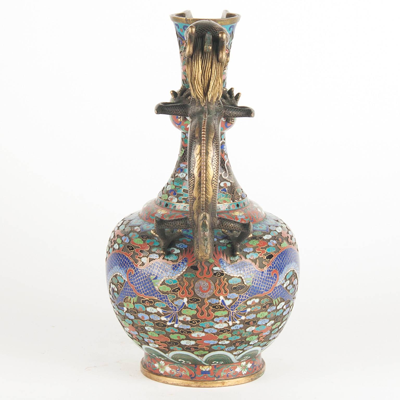 Chinese cloisonne ewer with floral decoration and gilt bronze dragon handle. The handle is decorated with Precious Stones,
late 19th century.
The ewer is signed at the bottom.