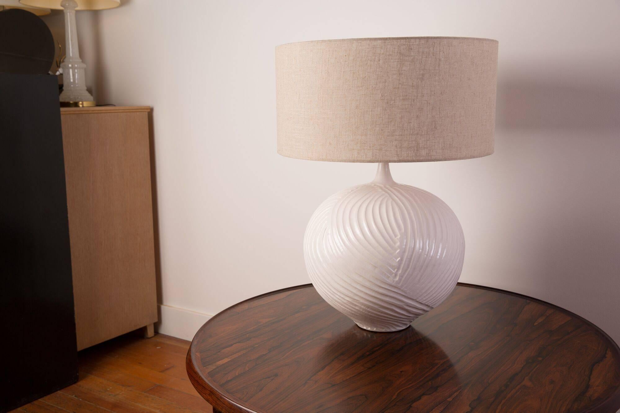 Hand textured ceramic lamp with a white glaze.