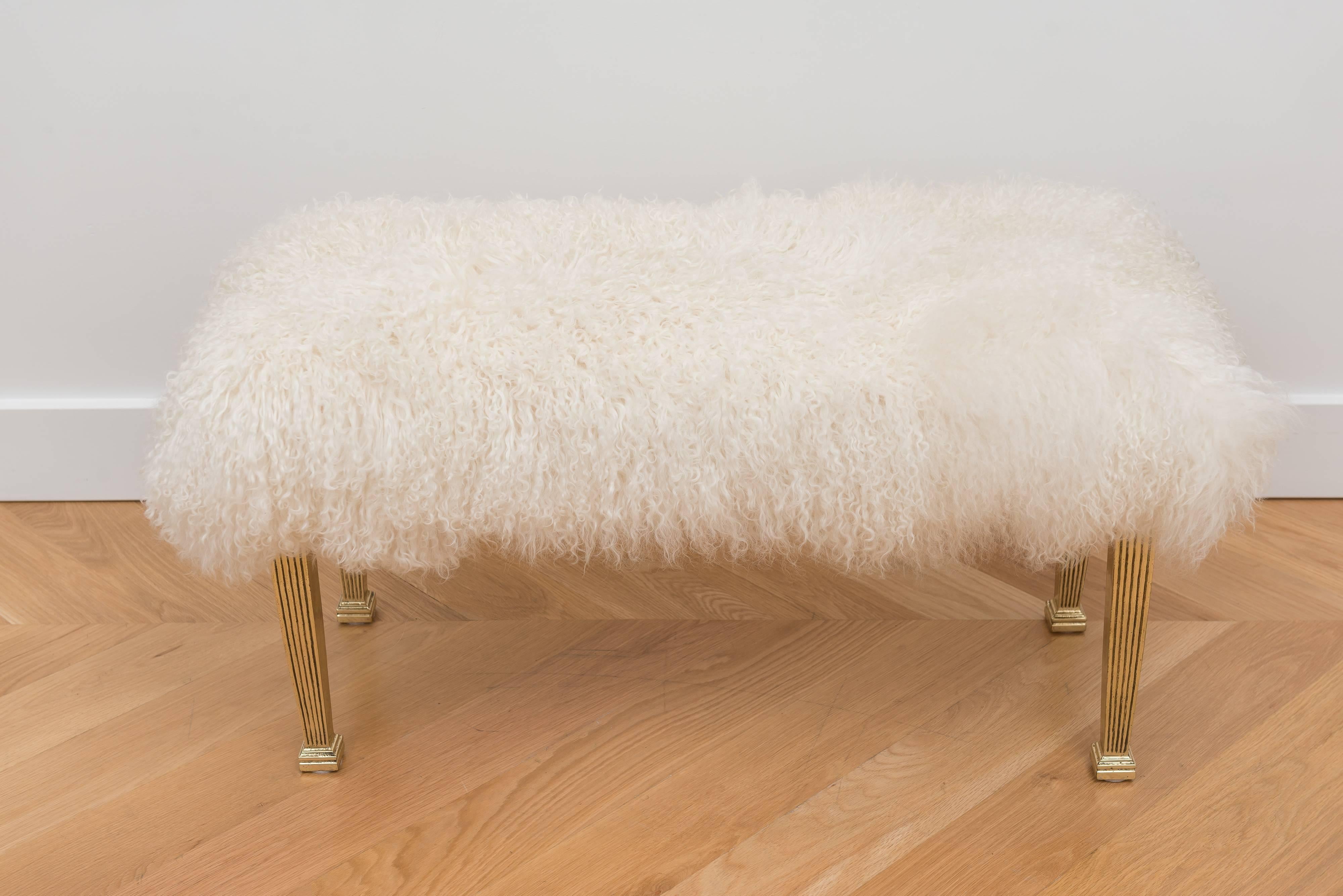 Mongolian wool bench with polished reeded brass legs.