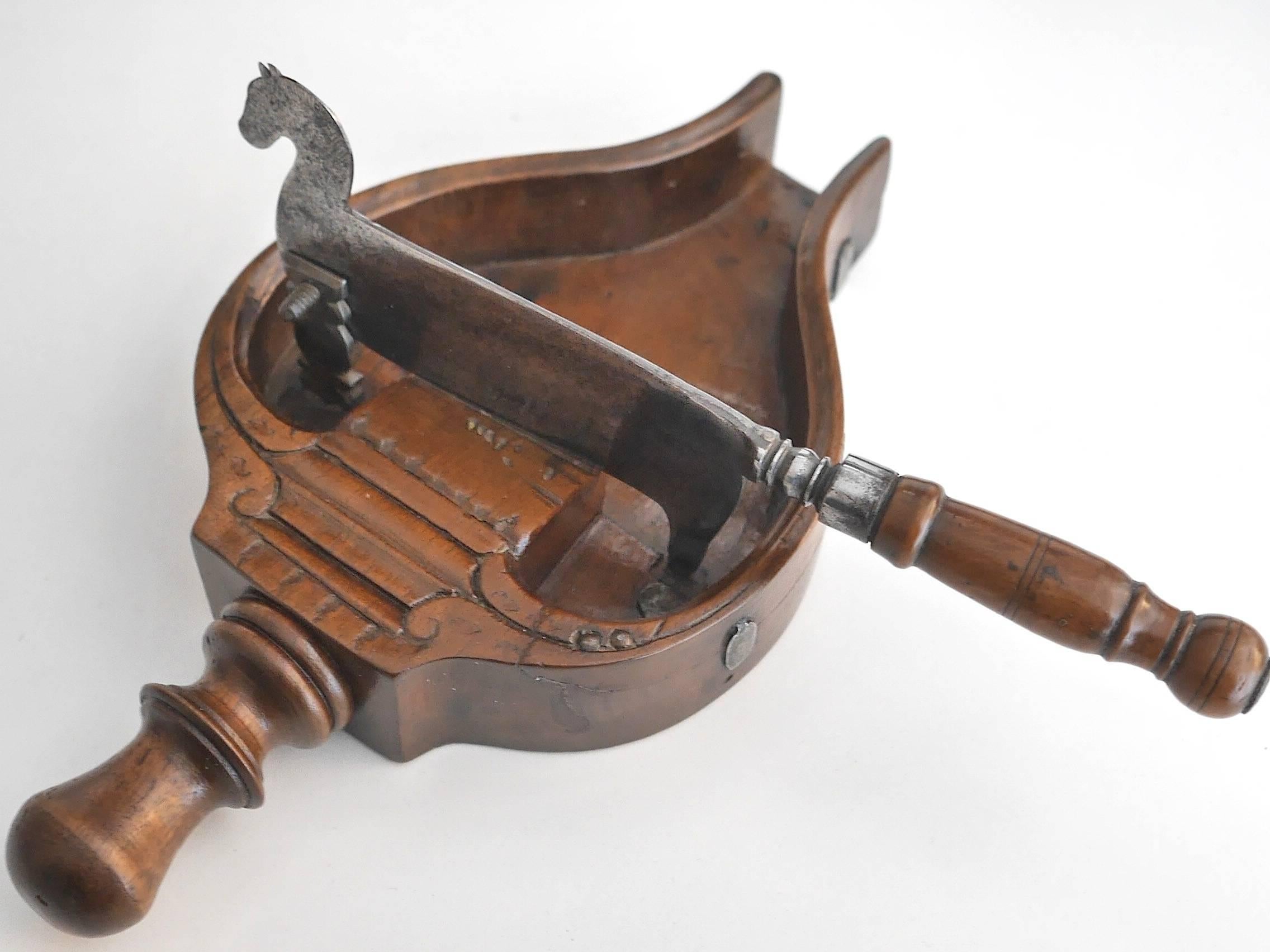 Boxwood and walnut chocolate chopper with a turned handle on both the horse shaped blade and the box. 
This type of instrument was commonly used for pastry.
 