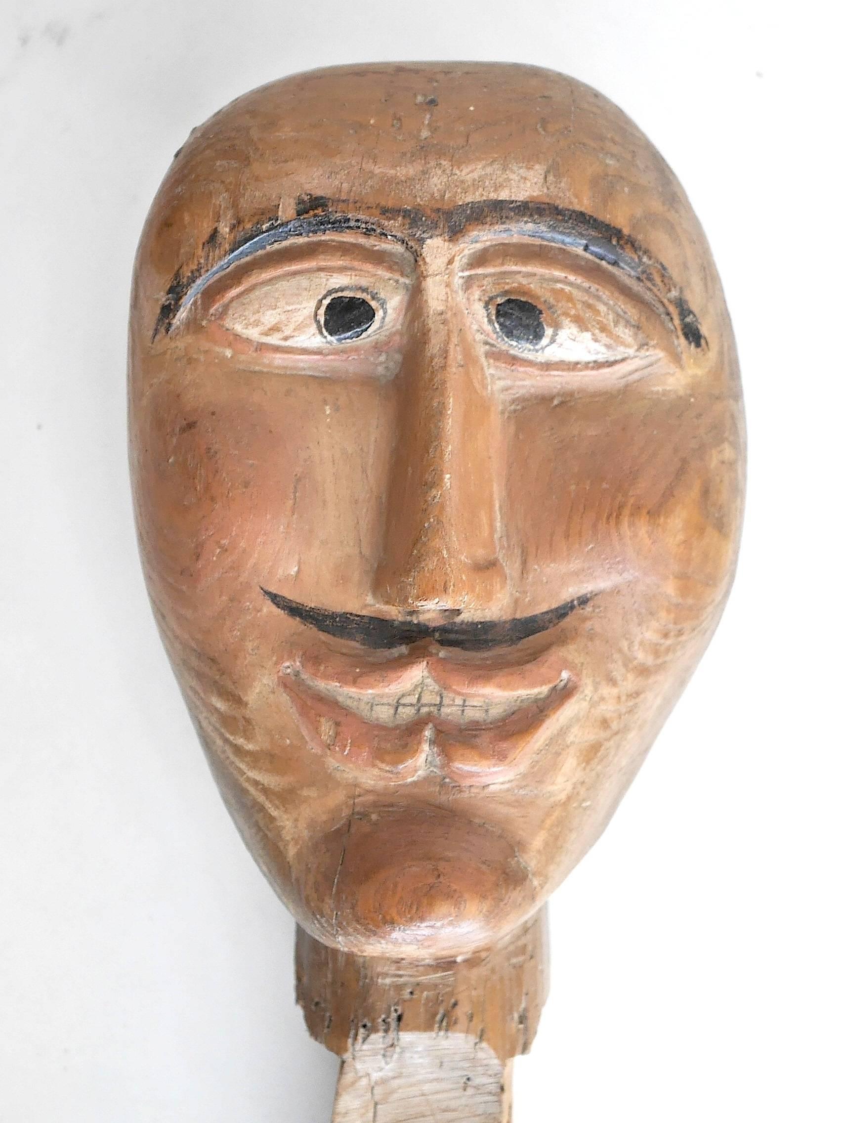 Rare Folk Art item.
That type of wooden heads were used in fairs as targets for small ball shooting games.
 