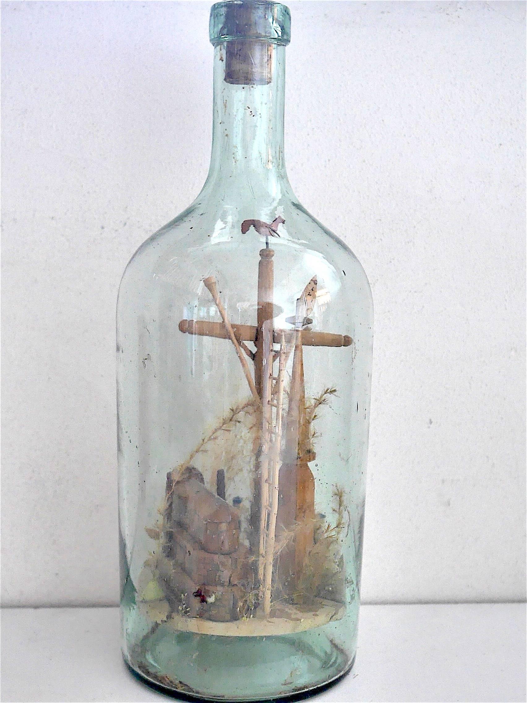 Decorative glass bottle, containing all the elements of Christian adoration.
Very fine work to introduce the element in the bottle.

Folk art representation of the crucifixion.
                       