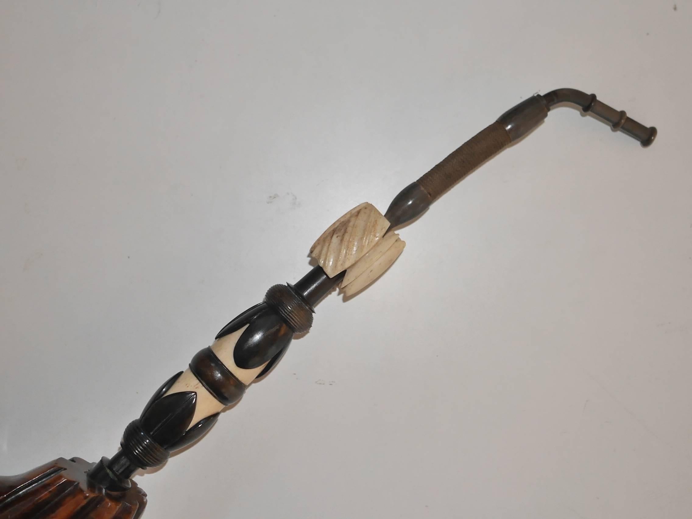 Rare giant beautifully carved heather pipe decorated with bone and Horn details. The mouthpiece is linked to the main part of the pipe by a flexible braided cord piece. 
It originates from the Var area, in south of France.
 