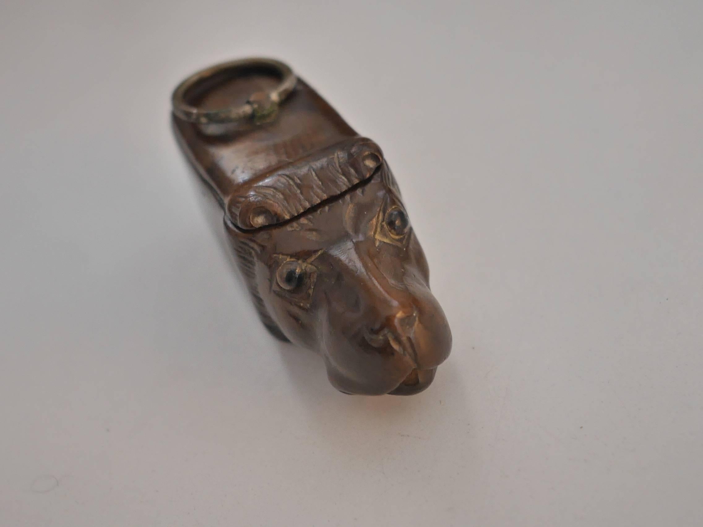 Little walnut tree snuffbox in the shape of a lion, with an opening on the back, helped by a silver ring. The face is really expressive, the eyes are made of glass.  Lions were very popular at that time, they represented power 