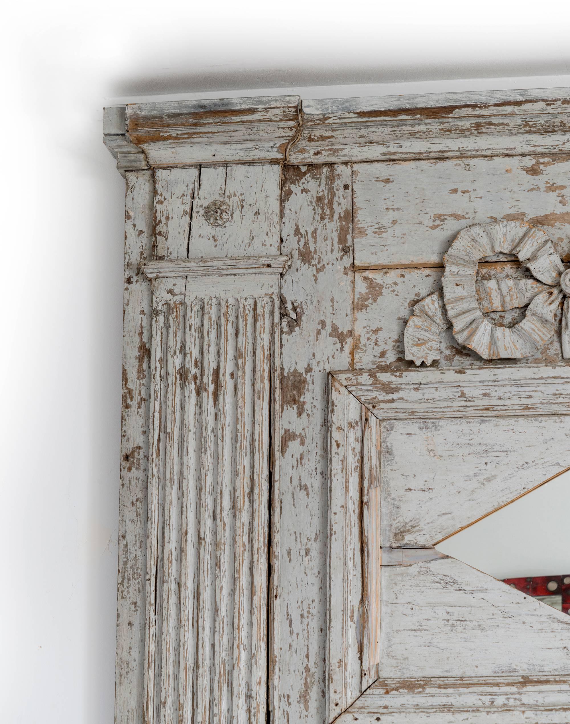 French, circa 1780. A very rare large-scale white painted Louis XVI trumeau mirror, decorated with carved wood Corinthian columns. This piece has been featured in Maison de Luxe from 2016 and showcased by famous interior designers. An incredible