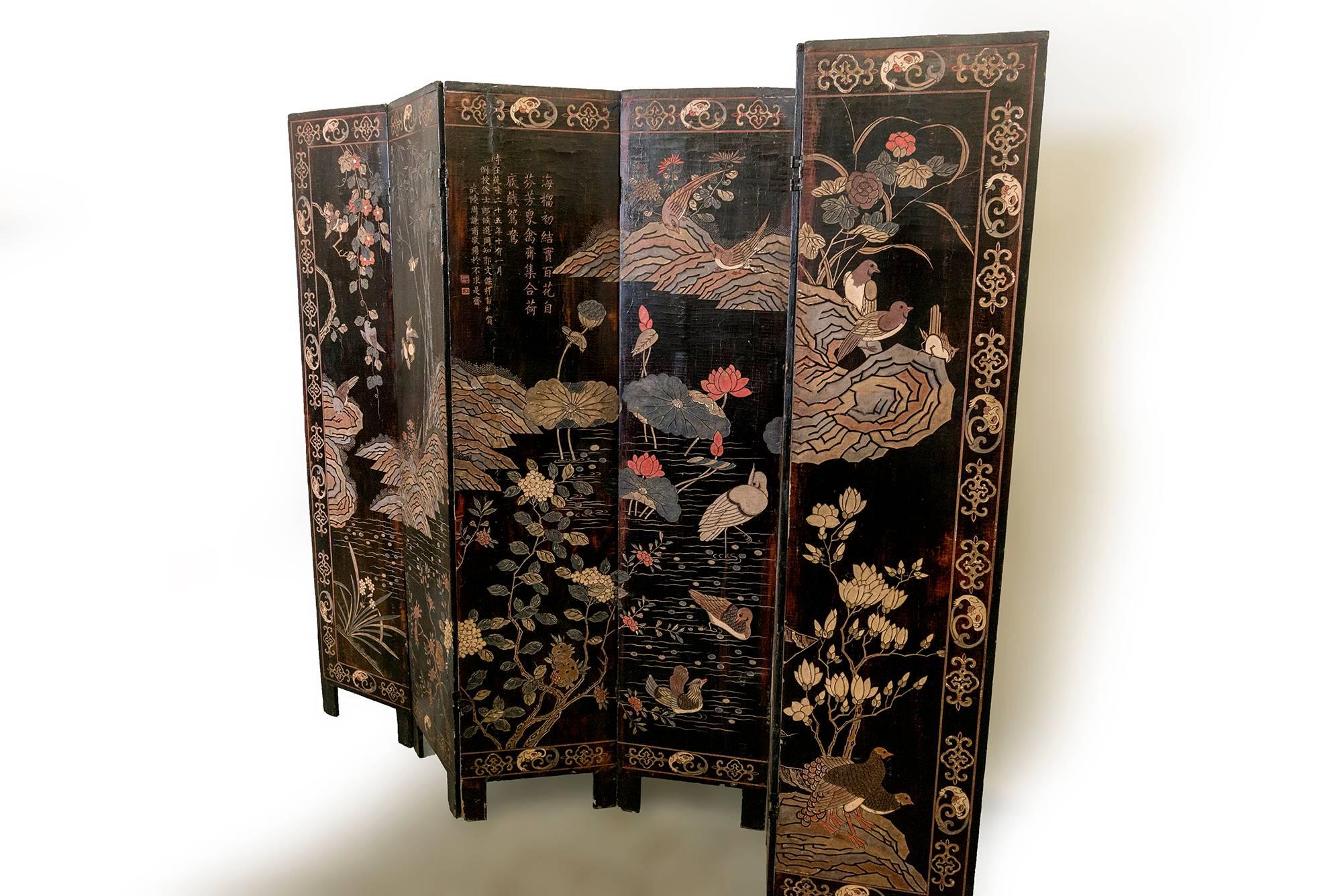 Six-panel double sided coromandel screen telling Chinese stories written in Hanzi characters. One side depicts Imperial court ladies in various activities; the other side depicts exotic birds in a Lotus pond. Signs of harmony, vitality, and