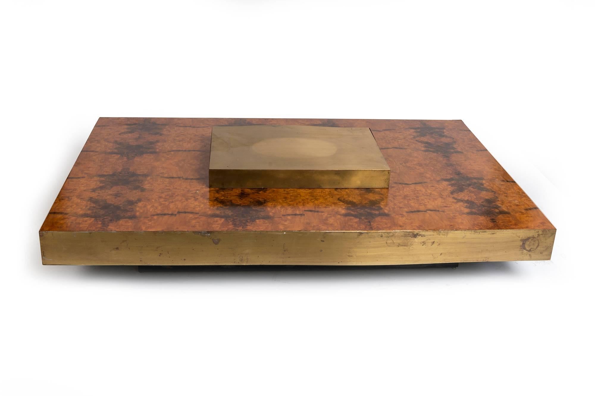 An unusual piece for a coffee table. Brass-trimmed with a brass inlay on the center of this low piece with lacquered wooden accents.