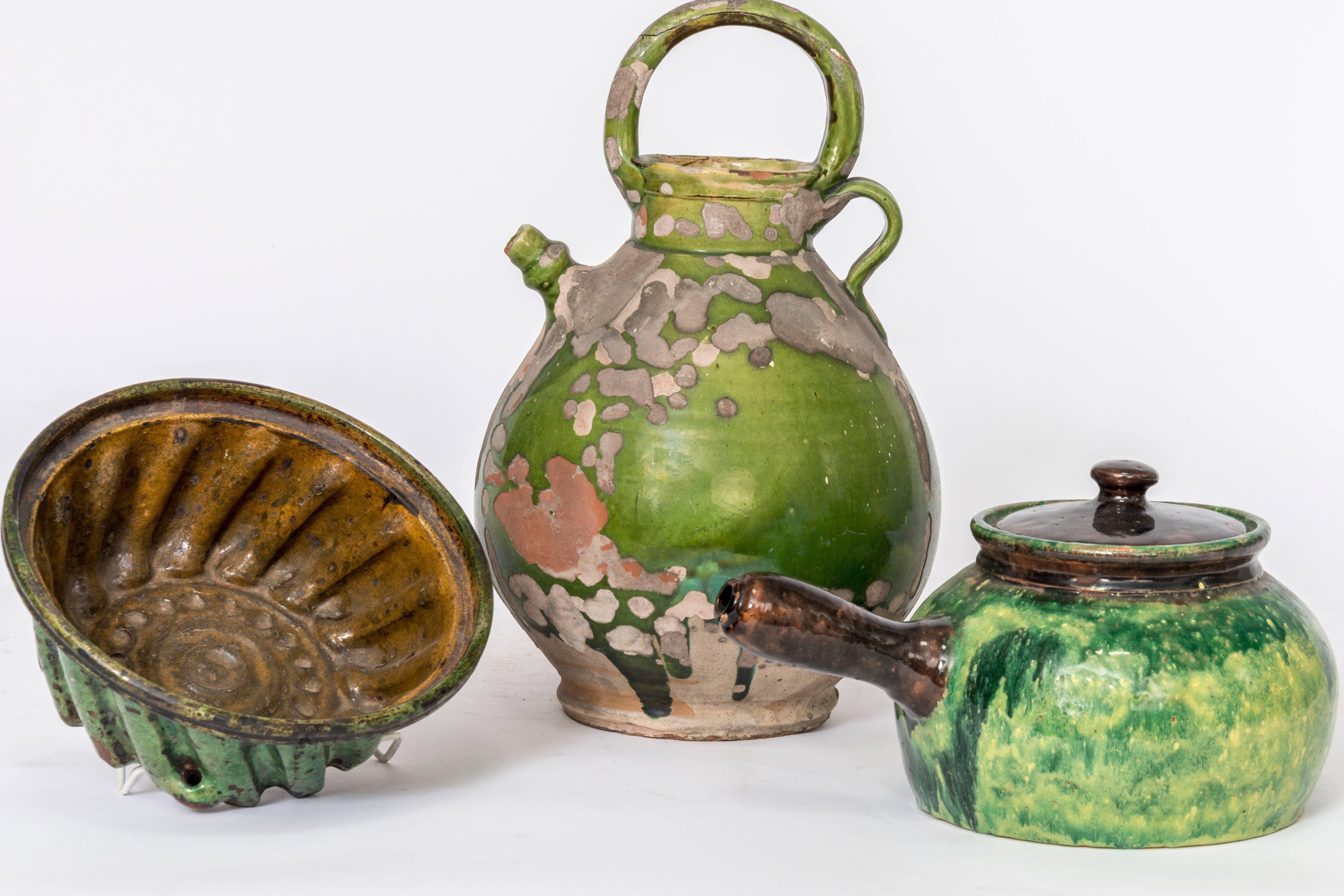 An assortment of French crockery as vases, vessels, plates, cooking mold, and creamers. Handmade and vintage, circa 1880.