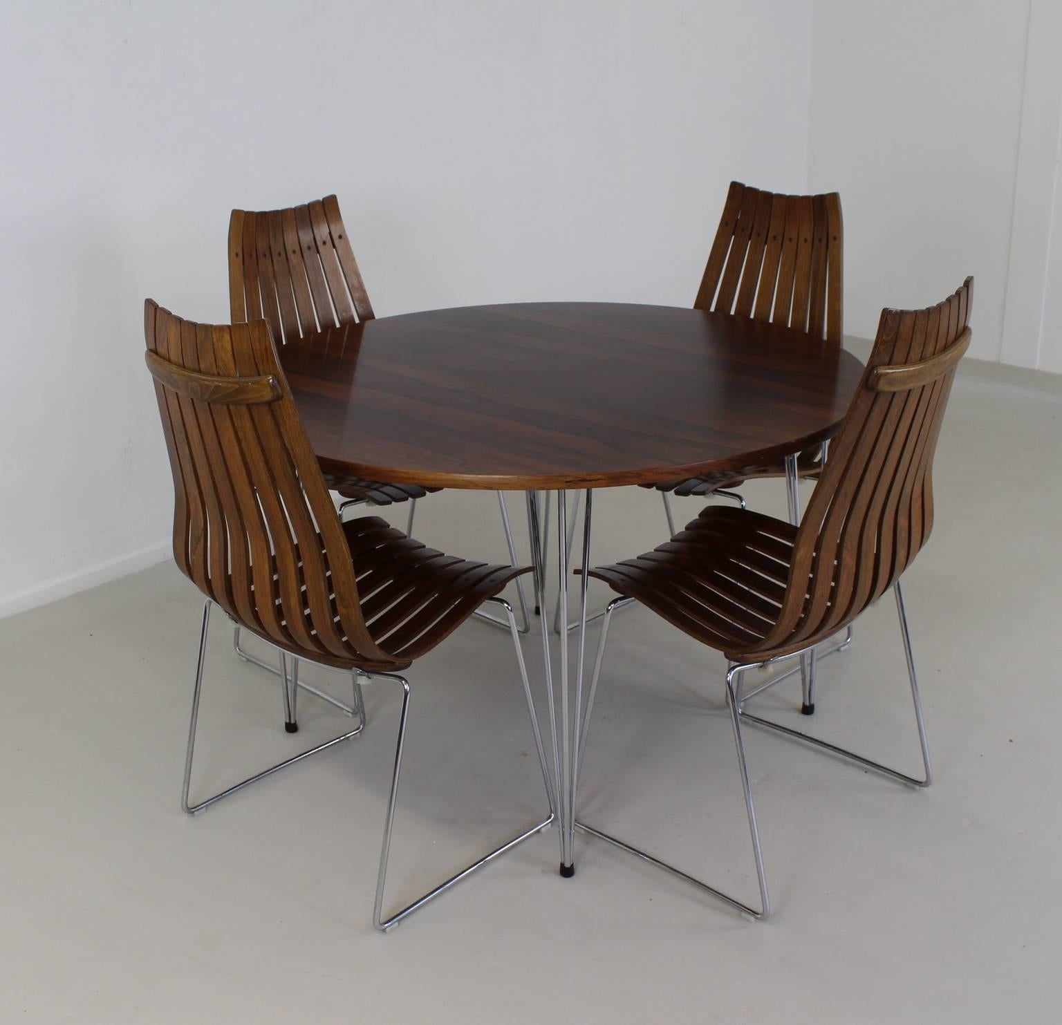 Exclusive dinner set with stackable dinner chairs.
Designer: Hans Brattrud in 1957.
Manufacturer: Hove Mobler Norway.
Chair model: Scandia.
Table also in rosewood and chromed legs.
Diameter: 115 cm.
Height: 72 cm.
      