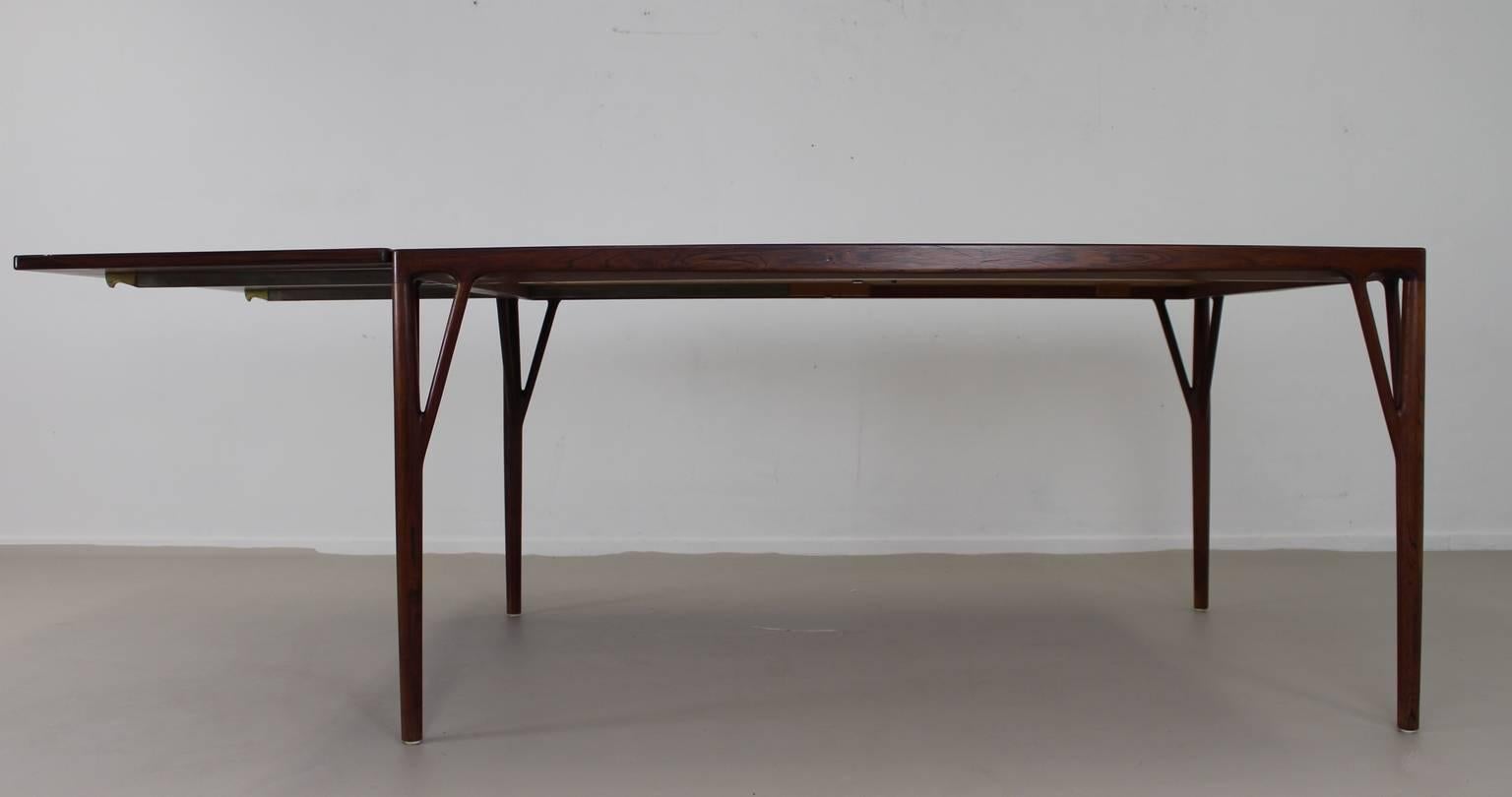 Incredible sculptural wooden legs integrated in the top of the table.
Design: Helge Jensen Vestergaard, 1956. 
Documented Mobilia, September, 1959. 
Rosewood and rosewood veneer. 
Total length of the table with flap is 220cm.
Supports of metal
