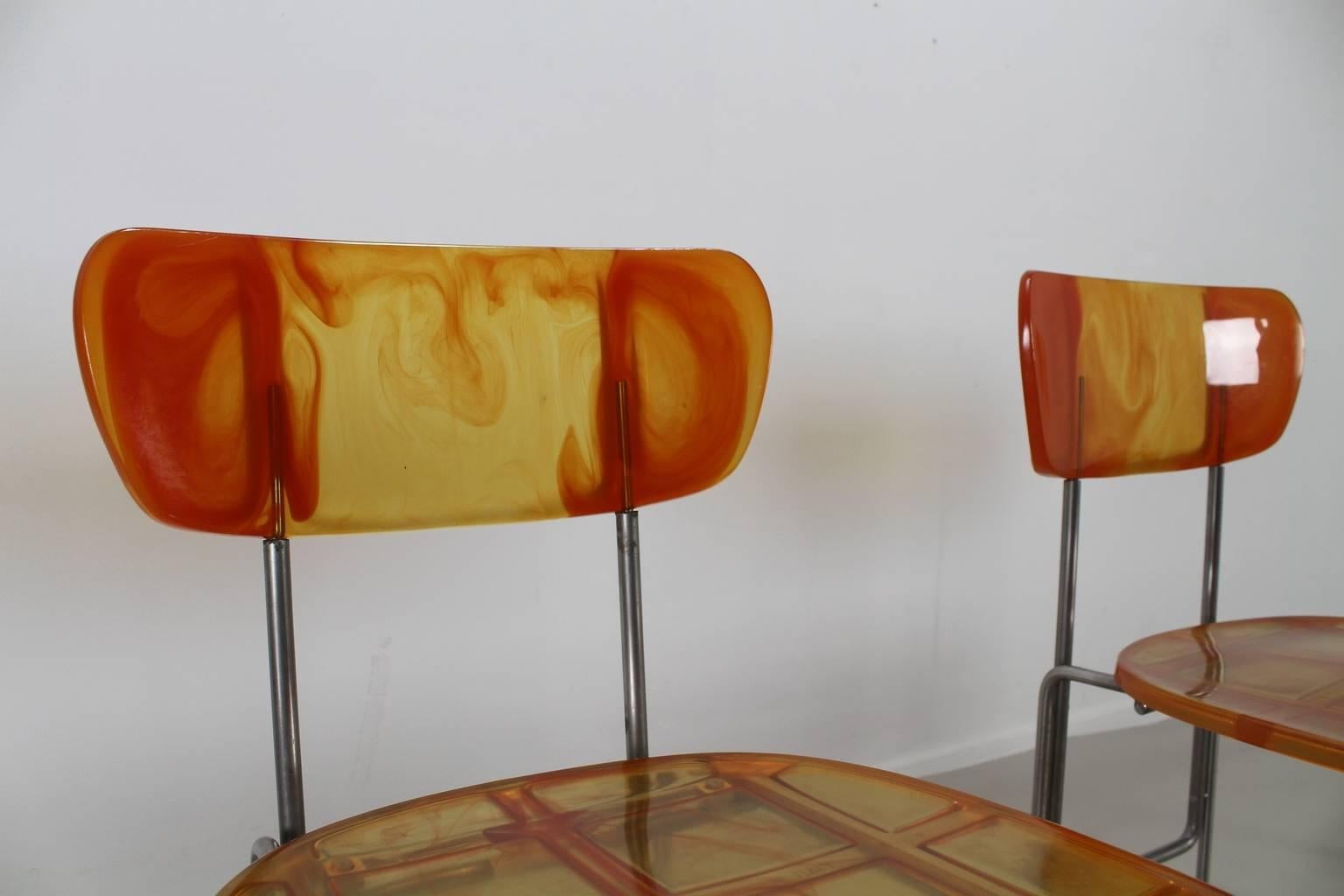 Beautiful set of four broadway chairs.
Designer: Gaetano Pesce.
Chrome-plated tubular steel. 
Polychromatic epoxy resin in yellow and orange. 
Legs with metal springs.
 