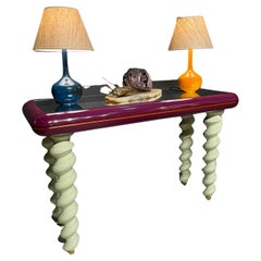 A 1970s,  lacquered wood, mirrored glass and brass,  Italian console table