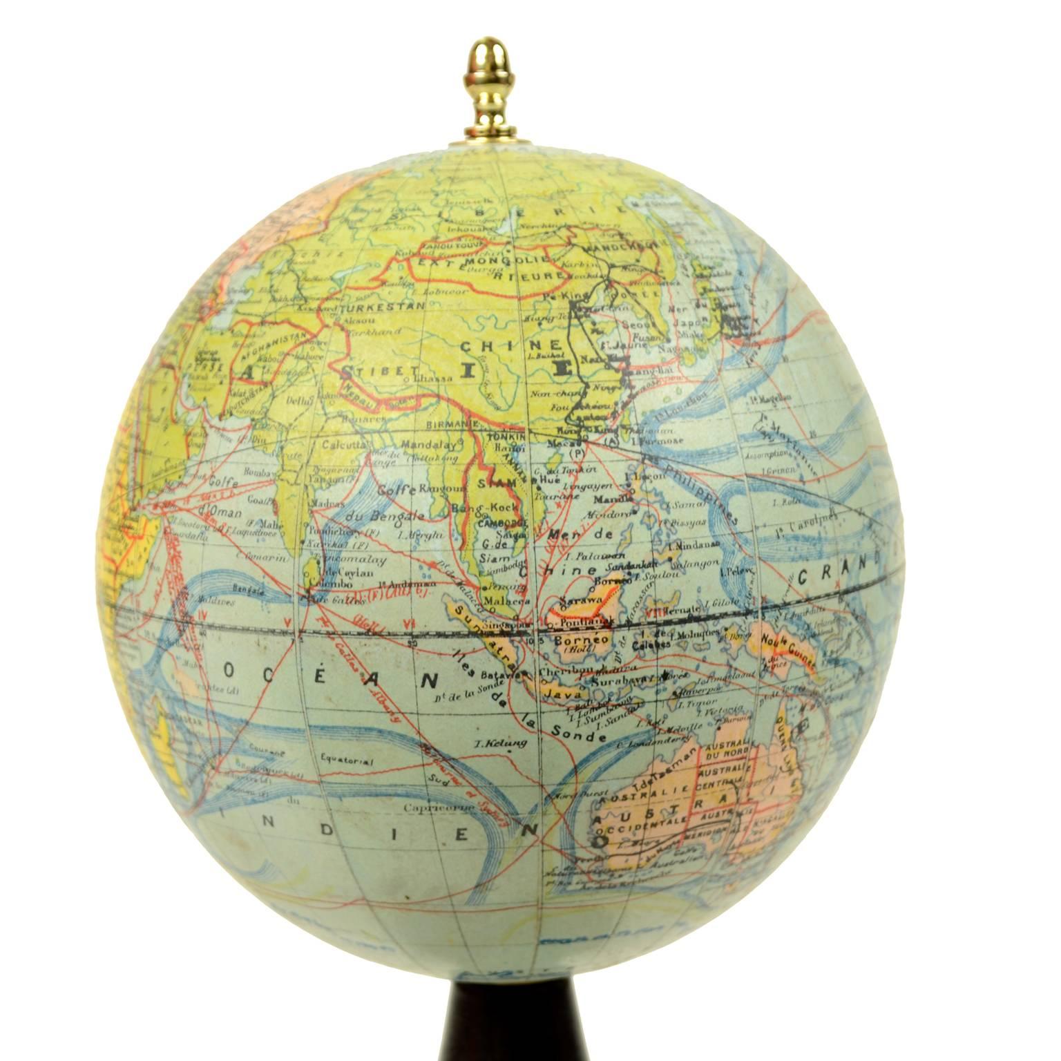Terrestrial globe edited by the French cartographer J. Forest in the 1930s. Besides territorial map there are ocean currents and main trade routes of that period. Papier mâché sphere and turned and ebonized wooden base . Height 32 cm, diameter of