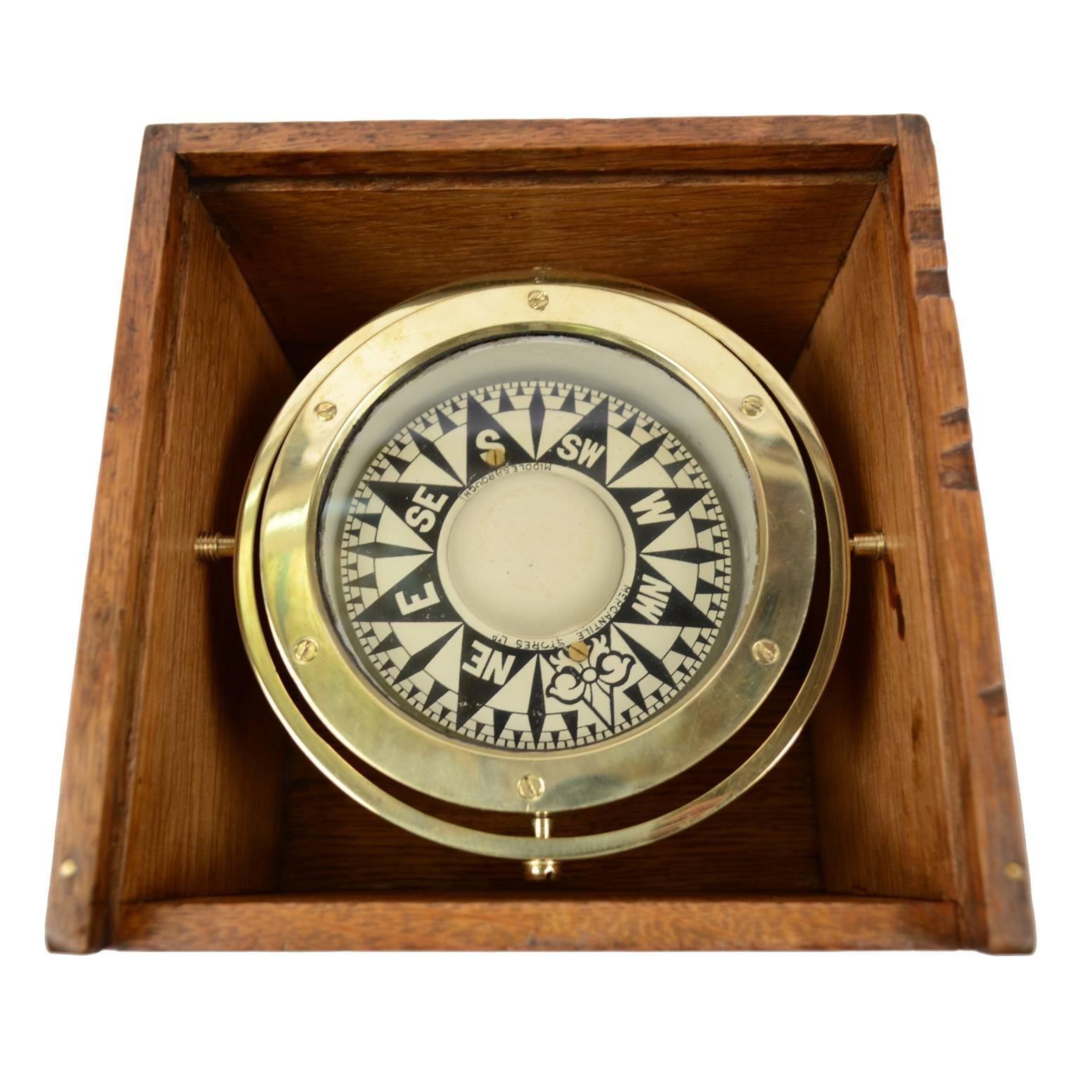 Nautical liquid compass made in 1920s, trade by Mercantile Stores Ltd Middlesbrough. It is mounted on universal joint and placed in its original wooden box. Measures: cm 19 x 19 x 14(H). Very good condition and working.