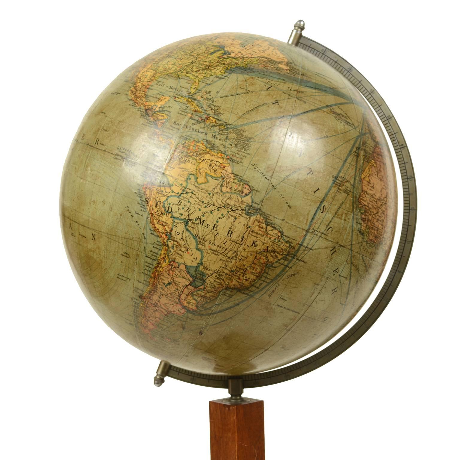 Globe published in 1930s by Columbus Erdglobus and the cartographers Dr. R Neuse and C. Luther, wooden square base complete with compass and meridian circle of engraved and chromium plated brass. Besides territorial maps very well defined this globe