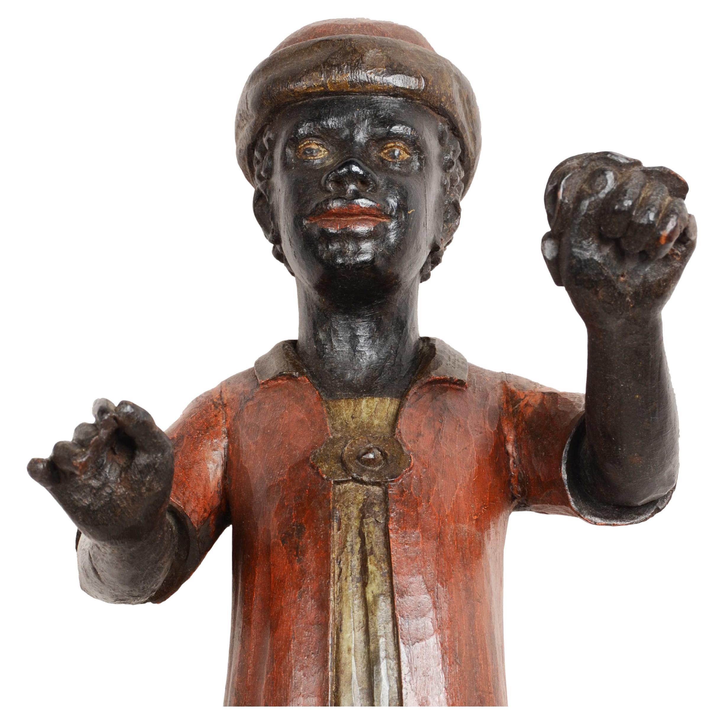 Pequeño mascarón de proa de madera tallada que representa a un joven Moretto, montado sobre una base de mármol rojo, fabricación veneciana, finales del siglo XIX.

Se trata de una escultura de excelente factura realizada en madera de álamo