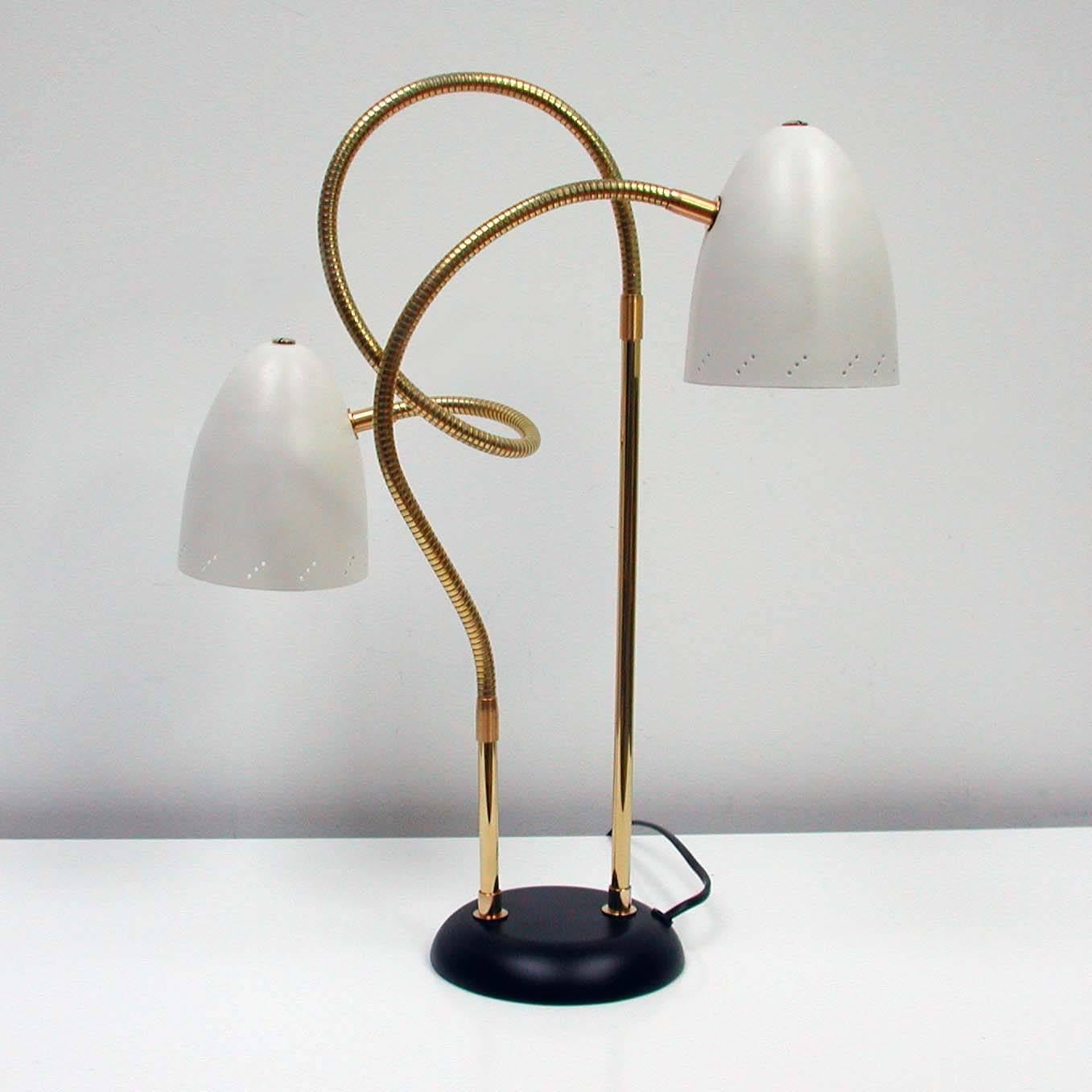 Awesome Italian Mid-Century Modern double gooseneck table lamp, made in the 1950s.
Excellent condition, rewired and all brass pieces polished. Two Shades in white lacquered metal (possibly relacquered at some time). Base black lacquered