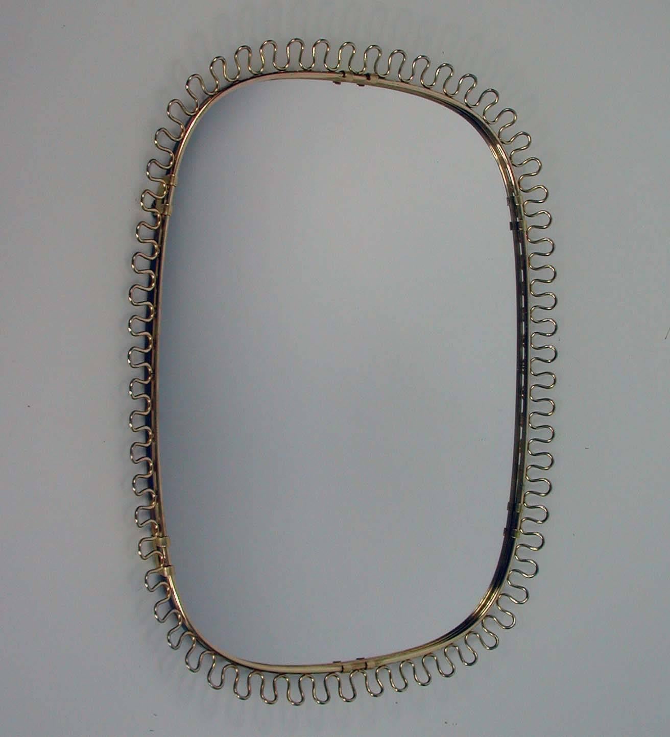 Beautiful brass loop wall mirror, by Josef Frank for Svenskt Tenn, Sweden, 1950s.
Both the mirror and the brass frame with warm original patina.