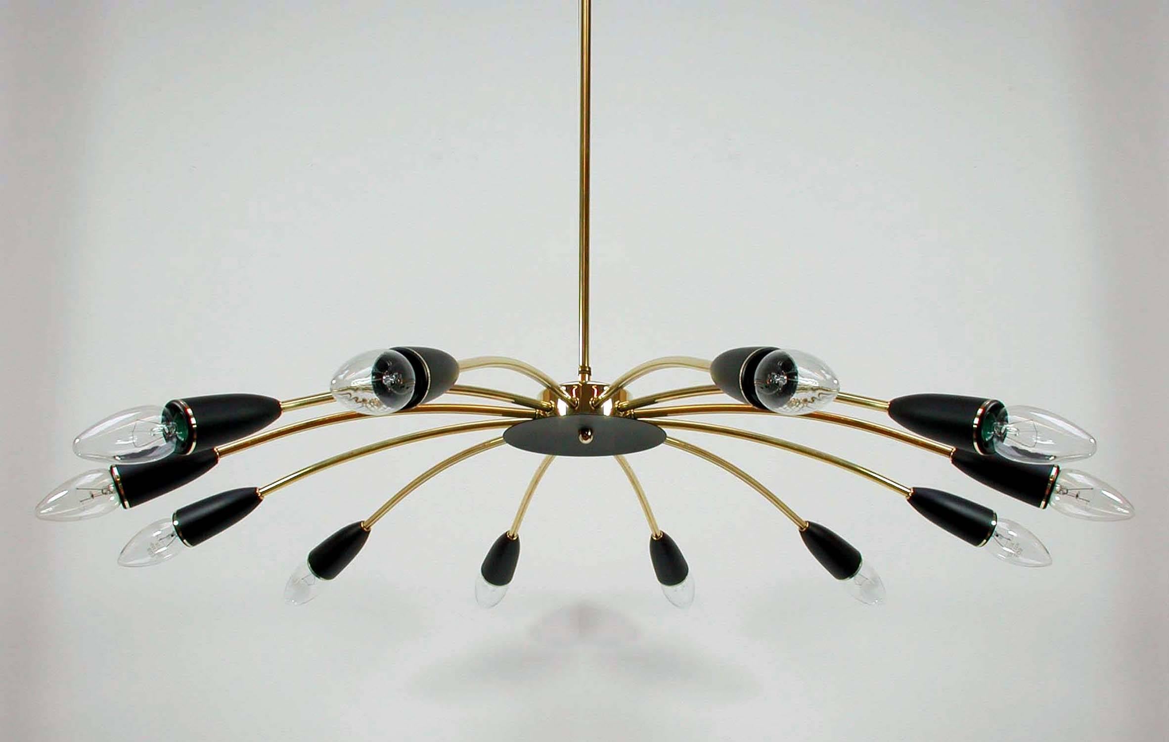 This elegant Sputnik style chandelier was manufactured in Italy in the 1950s. It is made of brass and has got 12 black lacquered bakelite bulb holders.
The brass lamp rod can be shortened or removed. When removed the chandelier can be used as a