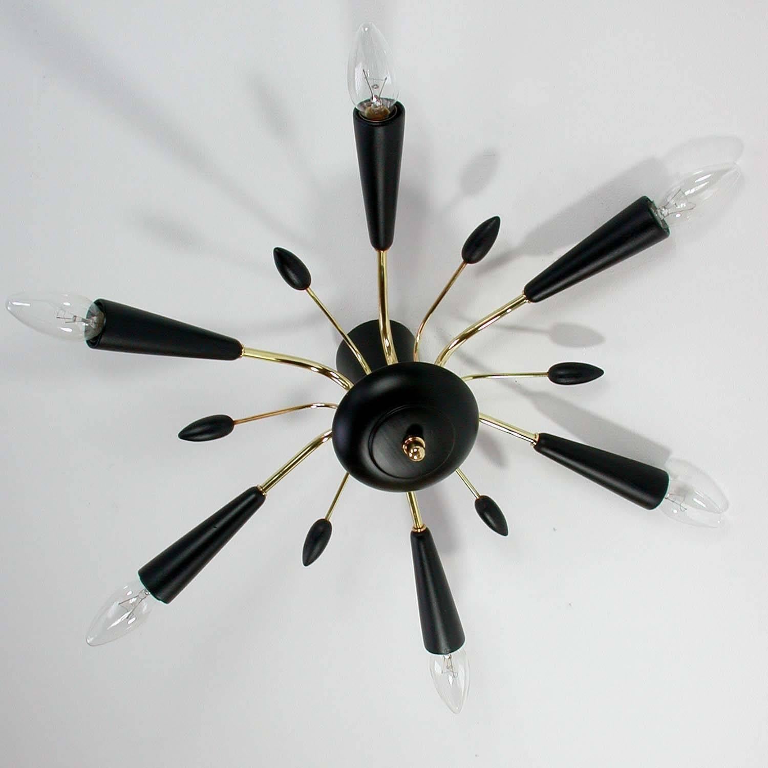 This Mid-Century Modern lamp was made in Italy in the 1950s. It is made of brass and black lacquered wood and has got six lights.
It can be used as a sconce as well as a flush mount. By attaching a lamp rod it can also be used as a chandelier.
  