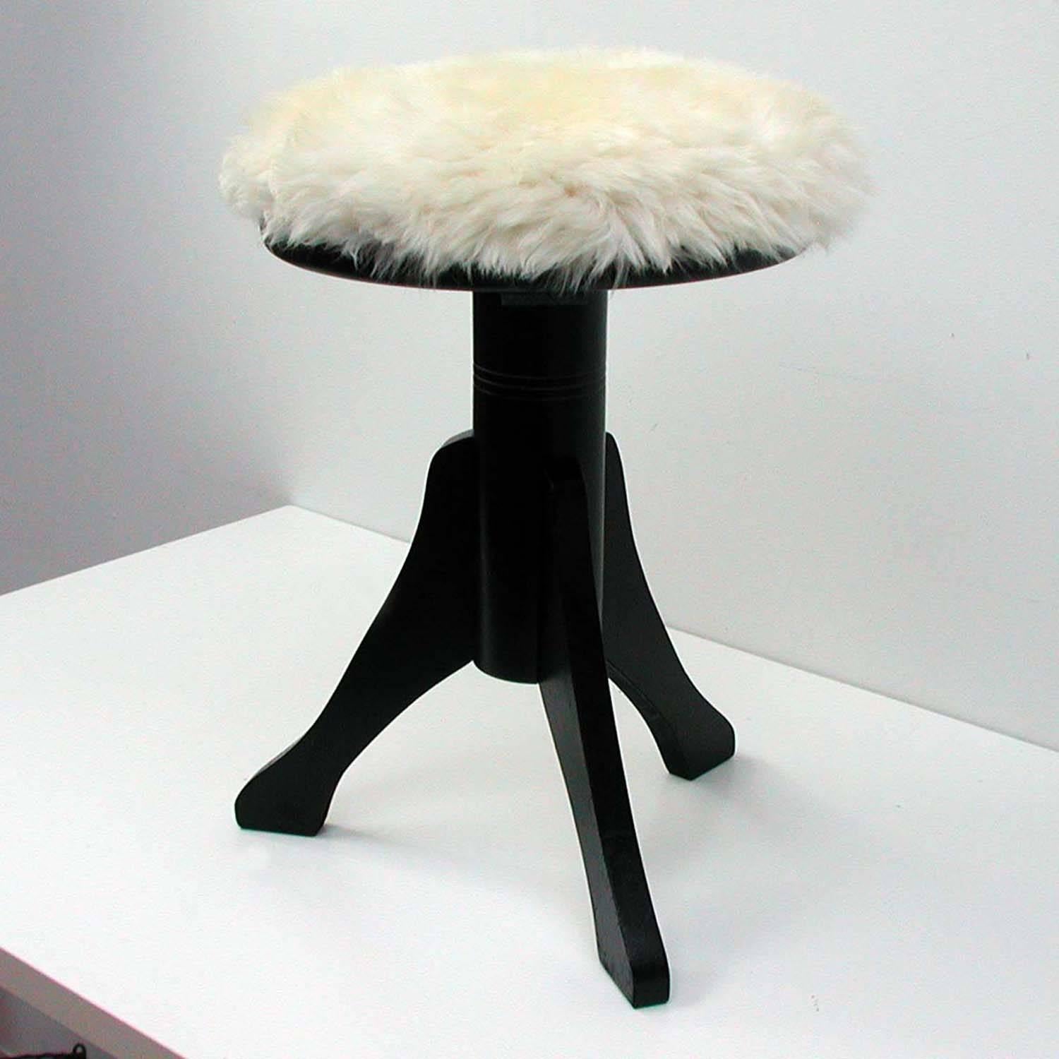 This piano stool was made in Germany in the 1920s.
It has got a black lacquered wooden (beech) adjustable base and was recently upholstered with new white Iceland sheep / lamp fur.
Measures: Height min 21