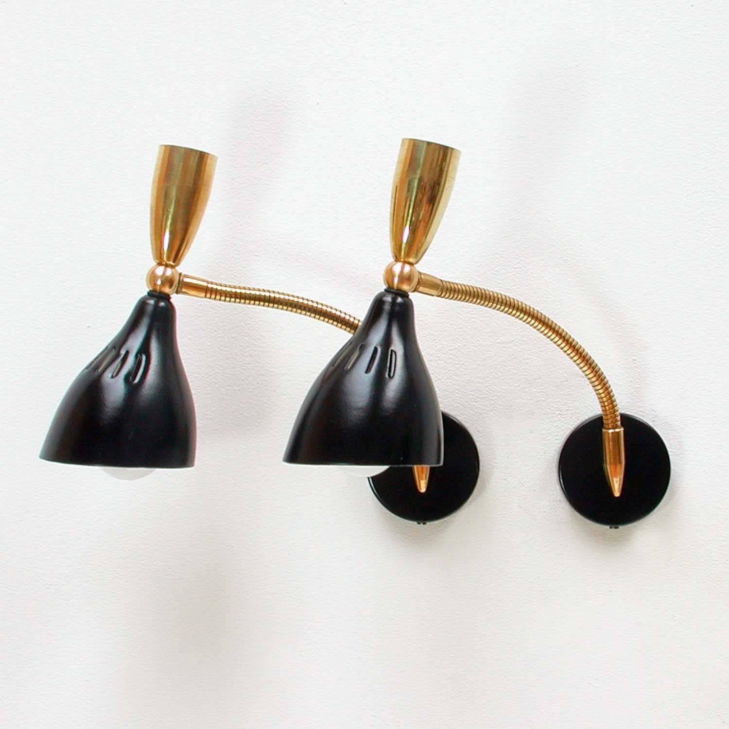 These pretty wall lights were designed and manufactured in Italy in the 1950s.
They are made of black lacquered metal and brass and have got adjustable brass gooseneck lamp arms.
Both lamps have been rewired.
The sconces are in excellent vintage