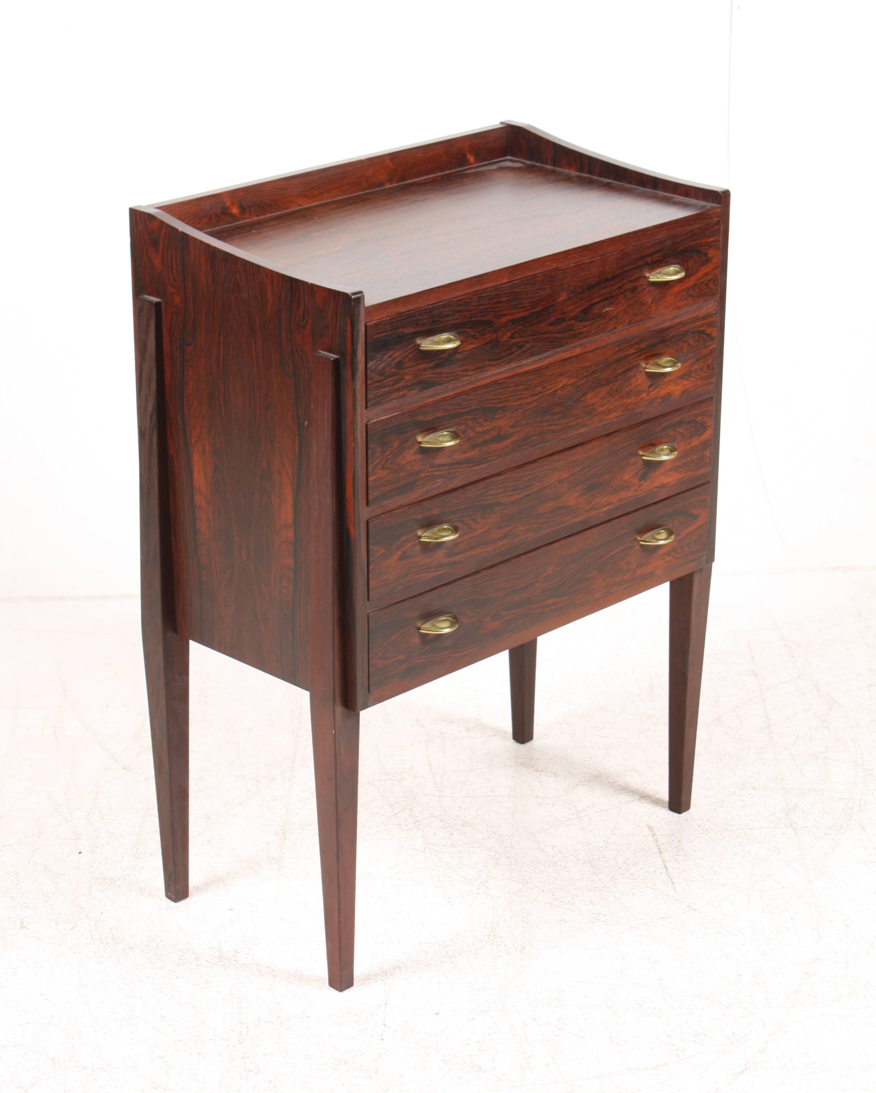 Elegant chest of drawers in rosewood with hardware in brass designed by Frode Holm for Illums Bolighus in the 1950s. Great original condition.