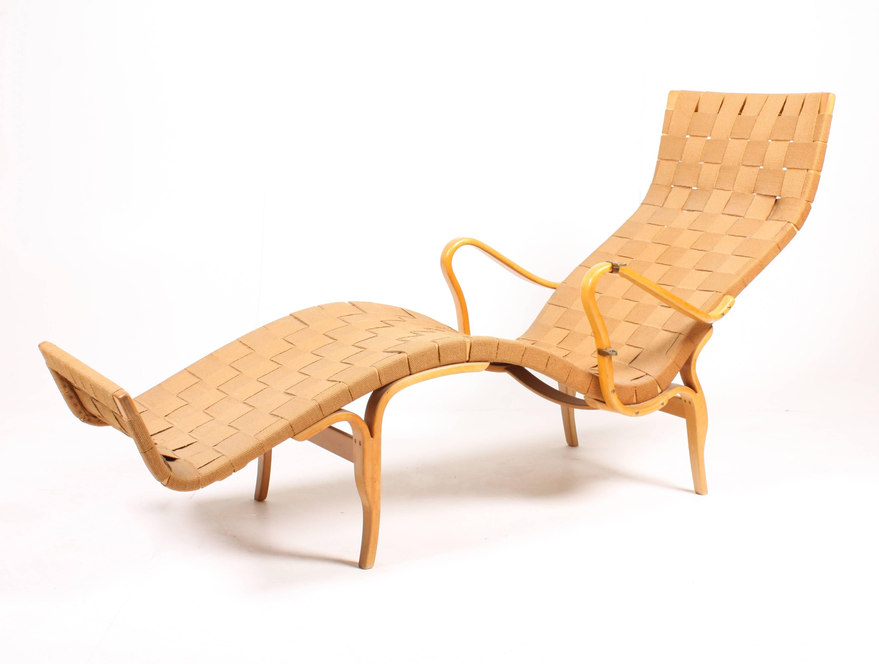 Bruno Mathsson lounge chair with adjustable writing table and original hemp webbing. Seatframe, arms and underframe of laminated beech. Produced by Firma Karl Mathsson

Bruno Mathsson was born to cabinet making. His father, Karl Mathsson was the