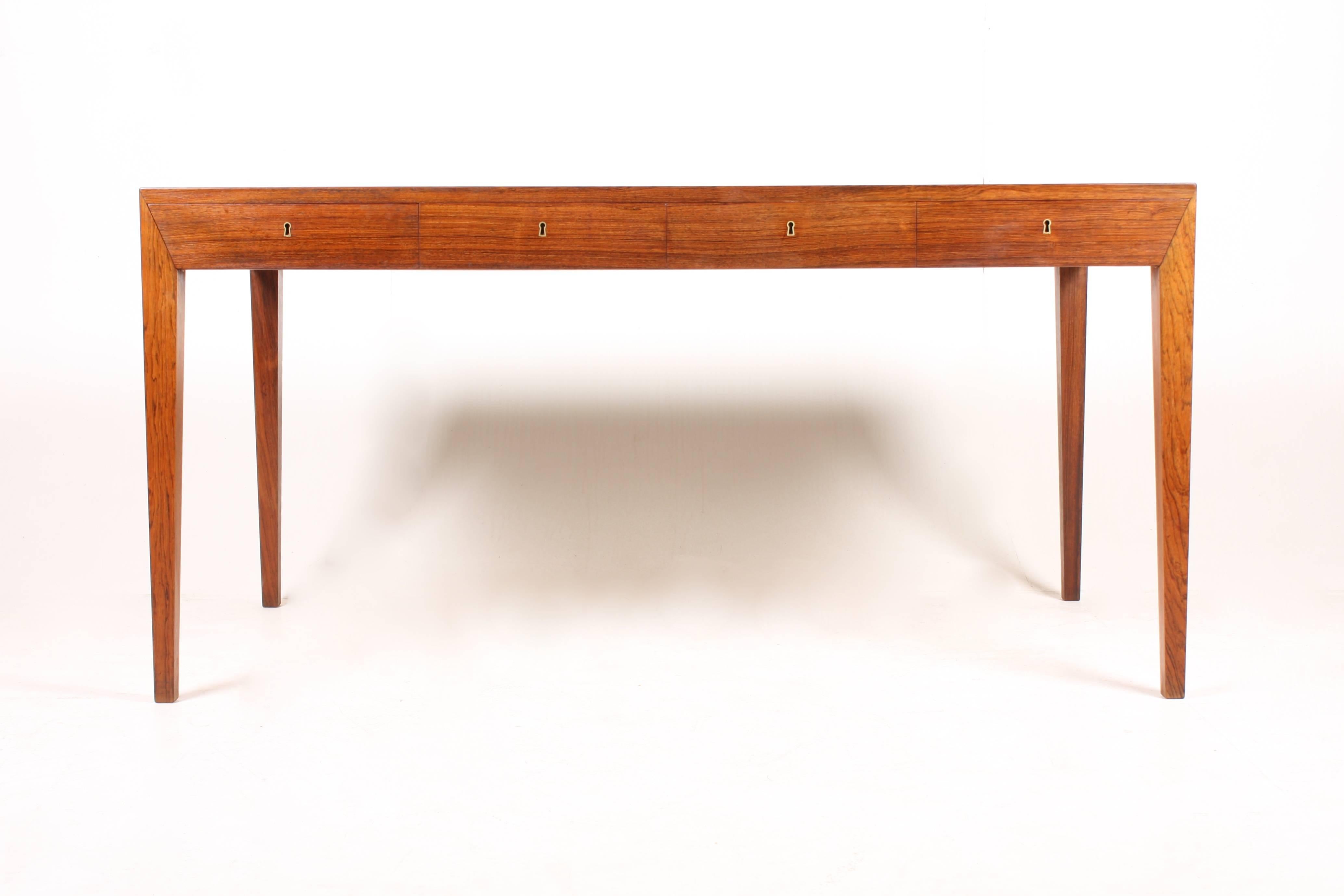 Elegant freestanding Danish design rosewood desk with four drawers designed by Severin Hansen Jr. for Haslev Furniture in the late 1950s. Made in Denmark, Great original condition.