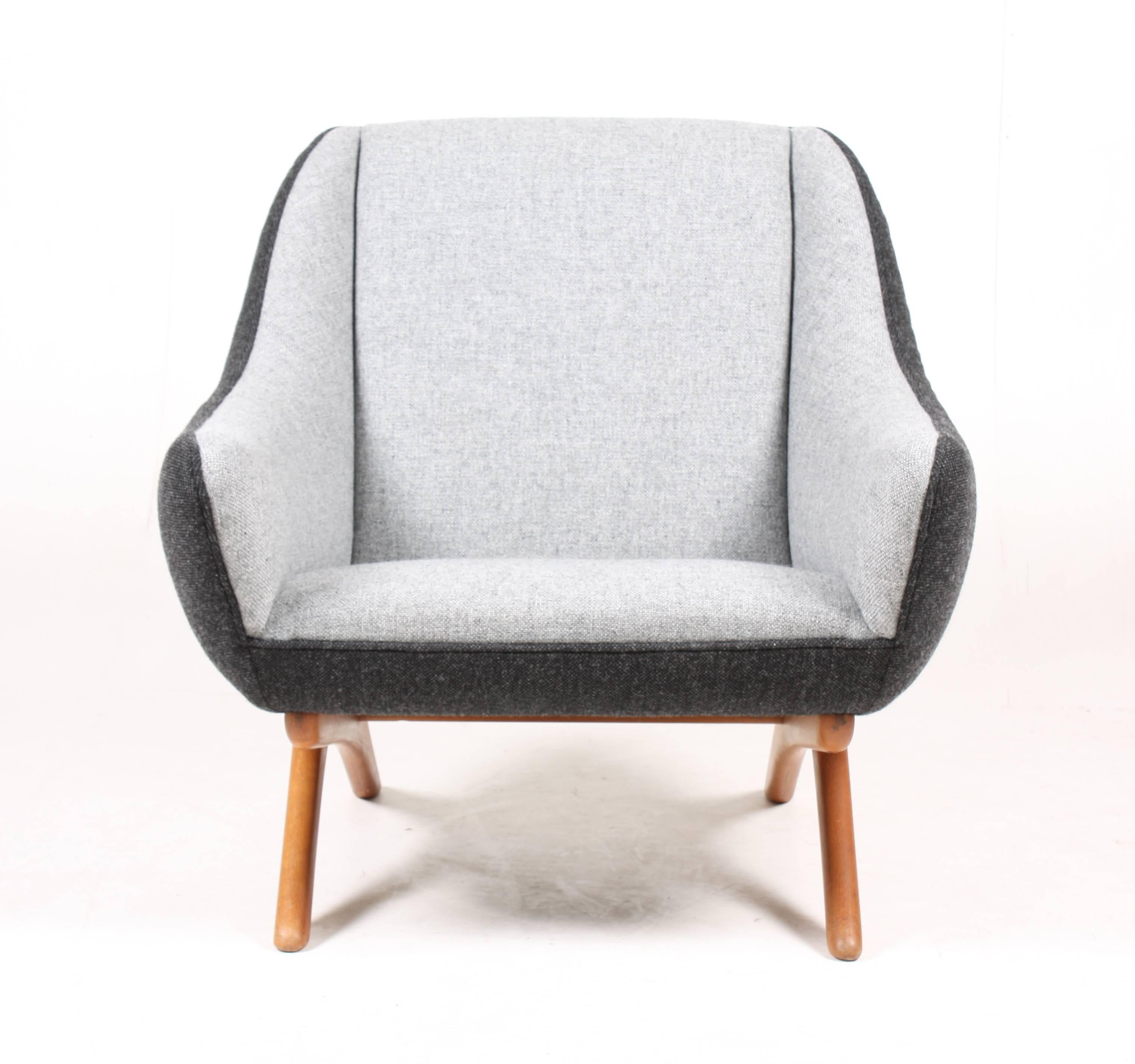 Lounge chair and ottoman in oil finished oak and new fabric by Kvadrat. Designed by Maa. Illum Wikkelsoe for Mikael Laursen cabinetmakers. Made in Denmark in the 1950s great condition.