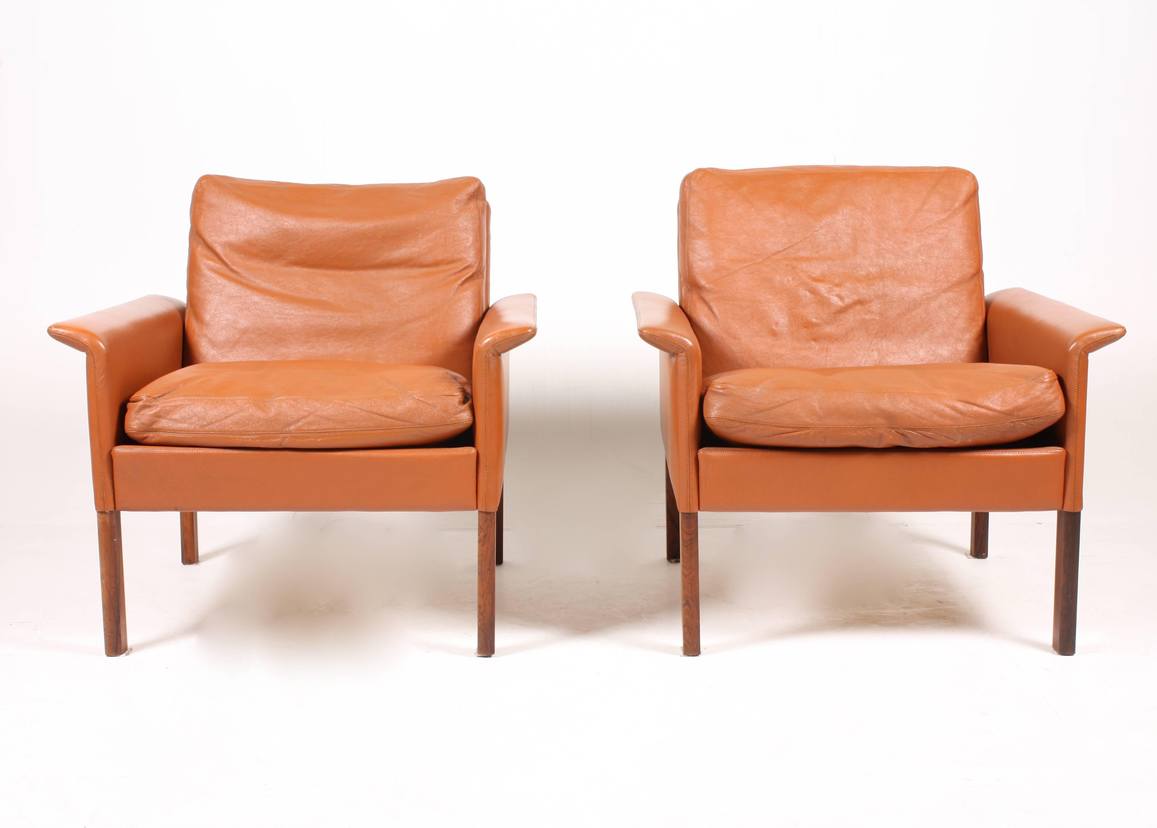 Pair of lounge chairs in patinated leather designed by Maa. Hans Olsen for CS Møbler in the 1960s. Made in Denmark. Great original condition.